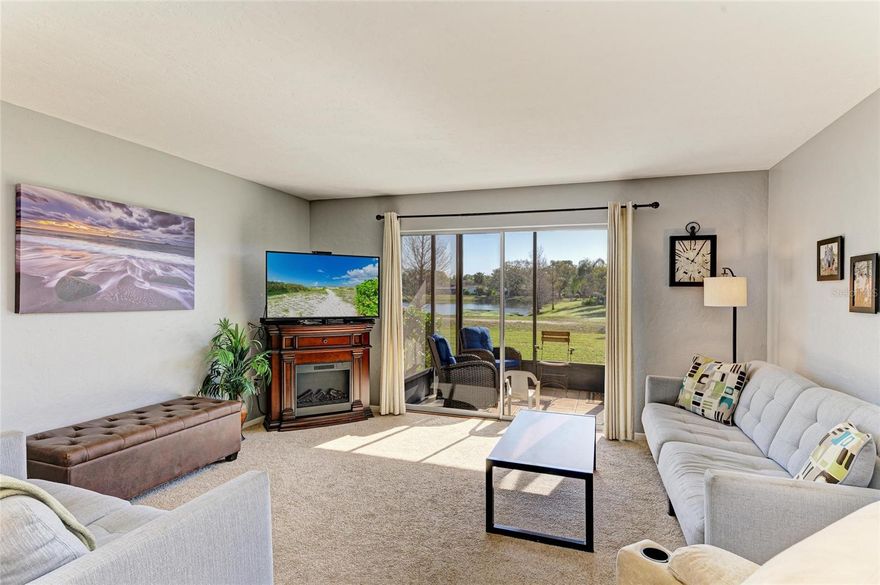 BEST VIEWS IN THE COMPLEX! IMPACT GLASS WINDOWS AND FIRST FLOOR!! LOCATION, LOCATION, LOCATION WITH LOW CONDO FEES $450/MONTHLY! Only 7.5 miles to world famous Siesta Key Beach. Ground level 2/2/1 condo with spectacular pond view, screened lanai and outdoor access. Entry opens to foyer with beautiful living room and dining area combo.  Large living room has beautiful view of pond and golf course with sliding glass doors to screened lanai. Dining room has pantry/closet. Kitchen has appliances with window above sink. Hallway has full size stackable washer/dryer. Tranquil primary bedroom with garden view, built-in desk and closet. Primary bathroom with shower, new vanity and lights. Guest 2nd Bedroom with built-in closet. Guest bathroom with tub/shower and updated vanity.  AIR CONDITIONER REPLACED IN 2021. NEWER  screen enclosure, entrance door, dishwasher, microwave and sink faucet.  Close to shopping, dining, arts/culture, theme parks, major sporting events, Pinecraft Park, Legacy Trail and more! This is a must see!  Come enjoy the Florida lifestyle.