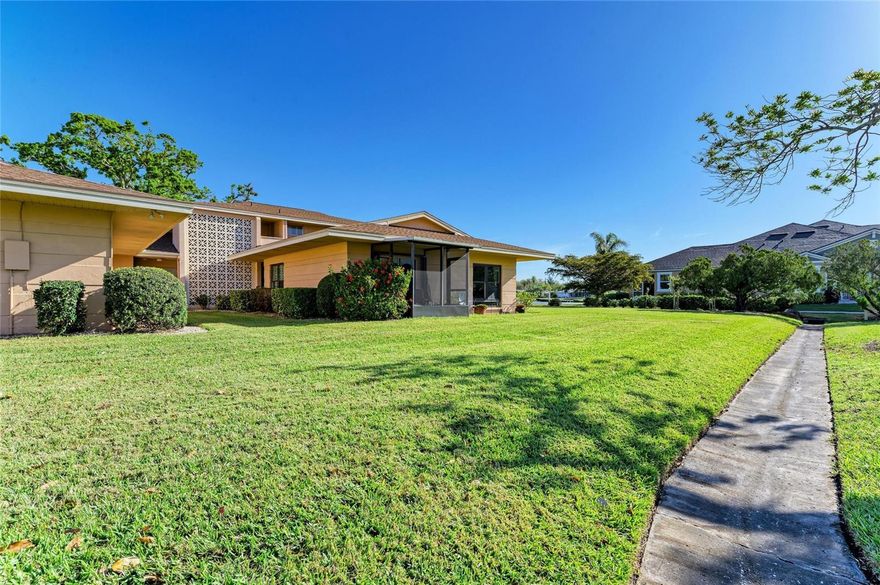 BEST VIEWS IN THE COMPLEX! IMPACT GLASS WINDOWS AND FIRST FLOOR!! LOCATION, LOCATION, LOCATION WITH LOW CONDO FEES $450/MONTHLY! Only 7.5 miles to world famous Siesta Key Beach. Ground level 2/2/1 condo with spectacular pond view, screened lanai and outdoor access. Entry opens to foyer with beautiful living room and dining area combo.  Large living room has BEAUTIFFUL VIEW OF POND AND GOLF COURSE with sliding glass doors to screened lanai. Dining room has pantry/closet. Kitchen has appliances with window above sink. Hallway has full size STACKABLE WASHER AND DRYER. Tranquil primary bedroom with garden view, built-in desk and closet. Primary bathroom with shower, UPDATED VANITY and lights. Guest 2nd Bedroom with built-in closet. Guest bathroom with tub/shower and UPDATED VANITY.  AIR CONDITIONER REPLACED IN 2021. NEWER  screen enclosure, entrance door, dishwasher, microwave and sink faucet.  Close to shopping, dining, arts/culture, theme parks, major sporting events, Pinecraft Park, Legacy Trail and more! This is a must see!  Come enjoy the Florida lifestyle.