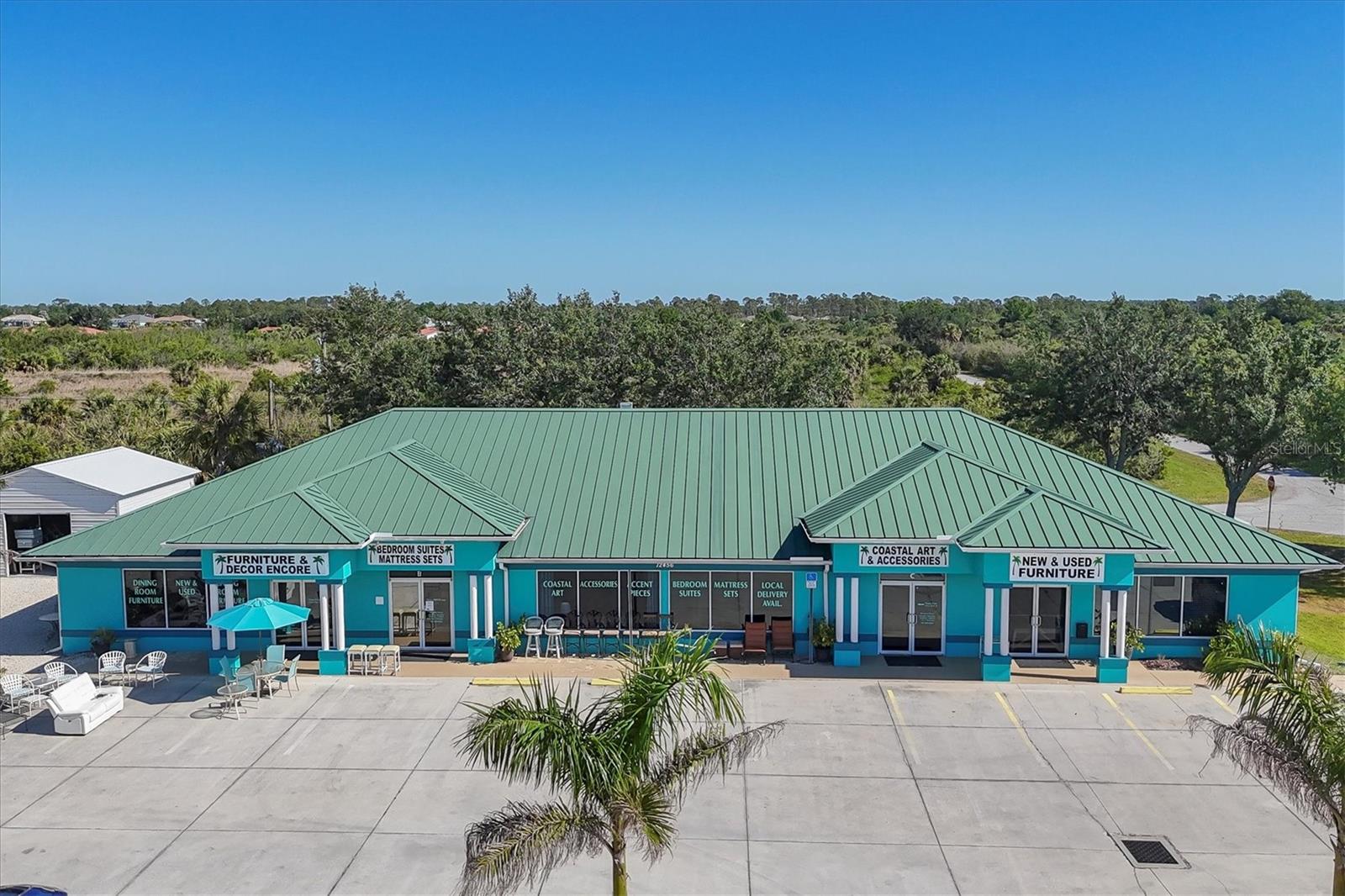 An exceptional opportunity awaits—seller lease-back is an option. This well-maintained commercial property at 12456 North Access Road in Port Charlotte offers both flexibility and long-term investment potential. Built in 2006, the expansive 5,916-square-foot building sits on 0.93 acres and includes four separately metered units, currently leased to the thriving business Furniture & Décor Encore. The property spans multiple parcels, with the main structure on three lots, a spacious parking area, and two additional lots housing 20-by-20 commercial sheds installed in 2023 on concrete slabs.
Zoned Commercial General, the site offers operational versatility for a wide range of commercial uses. Features include five bathrooms, block construction, a slab foundation, a metal roof, and a parking lot with ample space. Located directly in front of a newly approved 297-unit multifamily development, the property is ideally positioned for increased exposure and future growth.
The sale includes real estate only. The business is being sold separately—see MLS D6141946 (New & Used Furniture). Related businesses are also available under MLS D6142631 (Outdoor Furniture & Décor) and D6142629 (New Furniture). A bundled deal may be considered for qualified buyers.