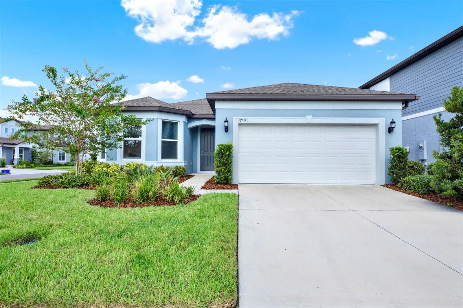 Welcome to 3791 Almond Brook Blvd in the sought-after gated community of Whispering Pines in Land O’ Lakes, FL! This 2-year-new Pulte Homes MEDINA floor plan offers a perfect blend of style, space, and function. Featuring 3 BEDROOMS and 3 FULL BATHS—including two ensuite bedrooms—plus a versatile flex space ideal for a home office, gym, or cozy den, this layout is designed to fit your lifestyle.
From the moment you walk through the front door, you’ll feel like you’ve stepped into the pages of a Crate & Barrel catalog. Every room has been thoughtfully designed with upgraded lighting, carefully curated color palettes, and furniture selections that create a sense of serenity and calm. And the best part? All furnishings are available for purchase, making this a truly move-in-ready opportunity. Storage is never an issue here—this home offers ample storage options throughout, including an additional storage area inside the laundry room. Situated on a fully fenced corner lot, the home boasts a spacious backyard with endless potential—add a pool, create a lush garden, or design your dream outdoor living space. Whispering Pines is a natural gas community, with service to each home powering the tankless water heater, dryer, and kitchen range. Residents enjoy resort-style amenities including a pool, playgrounds, and walking trails, all within a secure gated setting.
Conveniently located near top-rated schools, shopping, dining, and major commuter routes, this home offers the perfect balance of elegance, comfort, and community living.