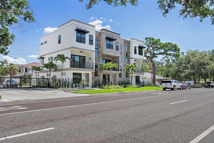 Now complete and move-in ready, this beautifully finished Strum Place residence offers modern living with timeless St. Petersburg charm in a secure, gated enclave of just nine luxury townhomes. This home features hardwood flooring throughout (no carpet), upper-stack cabinetry in the kitchen and wet bar, and an epoxied two-car garage floor. Spanning three levels, the flexible layout includes a ground-floor bedroom with ensuite bath and private entry, ideal for guests or a home office. The main level impresses with 10' ceilings, oversized windows, and an open kitchen, dining, and living space that flows to a private balcony, complemented by a large island, quartz countertops, walk-in pantry, ceramic tile backsplash, full KitchenAid appliance suite, and nearby half bath. Upstairs, two additional ensuite bedrooms include a spacious primary suite with walk-in closet, dual vanities, and frameless glass shower, along with a full laundry room with sink and extra storage. Every residence is elevator-ready with aligned closets on all levels, and one of the remaining homes includes a fully installed elevator. Situated on Central Avenue in a non-flood zone, Strum Place offers unbeatable access to the SunRunner, Pinellas Trail, shops, dining, downtown St. Pete, and the beaches—modern living, historic charm, and a rare opportunity.