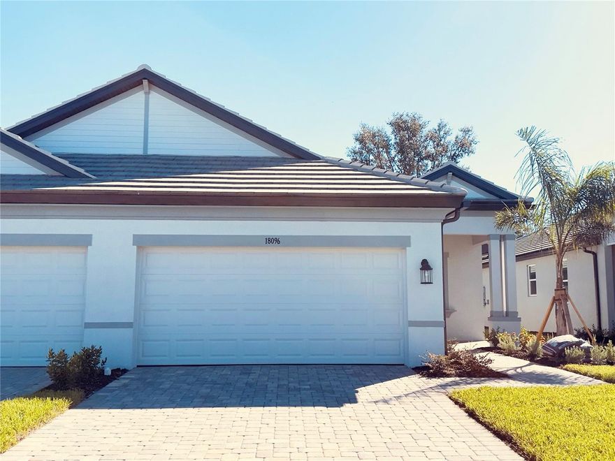 Discover your dream home in this meticulously crafted 2025 villa, featuring 3 spacious bedrooms, 2 modern bathrooms, and an attached 2-car garage. Nestled in a serene community, this elegant residence offers a peaceful view of established trees and a water view, enhancing the tranquility and beauty of your living experience. The heart of the home boasts an expansive, open-concept living area, adorned with stylish tile flooring that not only adds a touch of sophistication but also ensures easy maintenance. One bedroom is carpeted. Natural light floods the space, creating a warm and inviting atmosphere perfect for both relaxation and entertaining. The kitchen is a chef's delight with stainless steel appliances, sleek solid countertops, and ample cabinetry for all your storage needs. The open plan layout provides a picturesque setting for meals with family and friends, with views that seamlessly blend the indoor and outdoor spaces. Retreat to the master bedroom that has a walk-in closet, and an en-suite bathroom. The en-suite offers dual vanities, a spacious walk-in shower, and elegant fixtures, creating a spa-like oasis. The additional bedroom is adjacent to a well-appointed bathroom with modern amenities. One of the standout features of this villa is the screened lanai, an ideal spot for morning coffees, alfresco dining, or simply unwinding while enjoying the serene views. This outdoor haven adds an extra layer of living space and is perfect for year-round enjoyment, protected from the elements and insects. The attached 2-car garage provides ample storage and convenience, ensuring your vehicles and belongings are secure and easily accessible. Embrace the blend of luxury and comfort in this exquisite villa, where every detail has been thoughtfully designed to create a perfect sanctuary for modern living. Ceiling fans and window treatments are in progress to be installed.