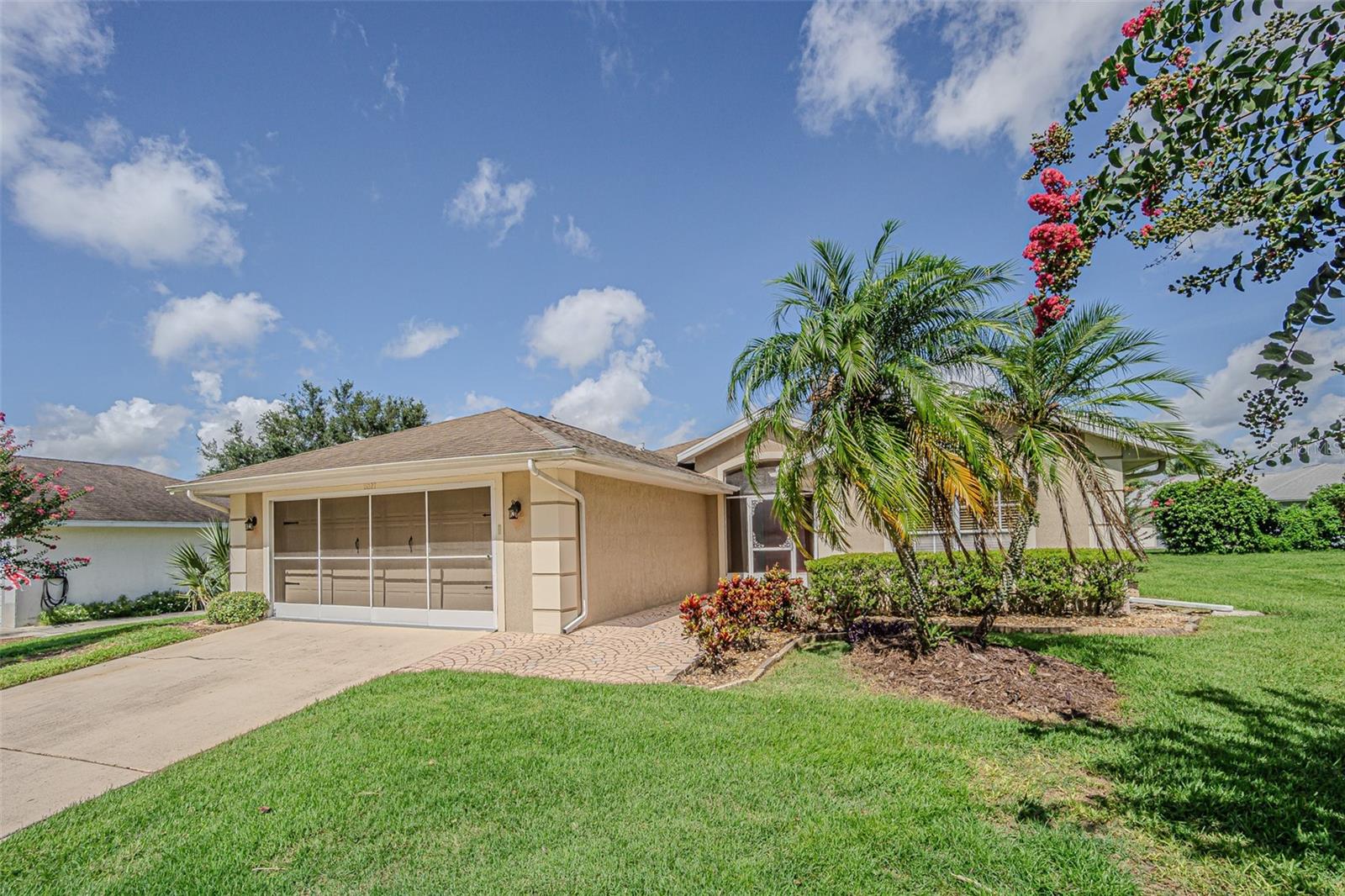 One or more photo(s) has been virtually staged. MOVE RIGHT IN and enjoy this 55+ guard-gated community of Tampa Bay Golf & Country Club! This well maintained and sun-filled 2 bedroom, 2 bath single-family home offers low-maintenance living with Stunning views overlooking the serene golf course. Inside, you’ll find a spacious kitchen with granite countertops, wood cabinets and ample prep and storage space. The formal dining area easily accommodates a table plus a buffet or hutch and the generous great room with sliding doors to enclosed lanai is ideal for entertaining. The primary suite features sliding doors to the Florida room, a large walk-in closet, dual vanities plus an oversized step-in shower. Additional highlights include wood-look ceramic tile flooring, an indoor laundry room with extra storage, and custom shelving and decorative niches. Numerous upgrades when purchased in 2014 included a newer roof and AC system, 2022 water heater and upgraded electric panel, tile floors, newly painted baseboards, washer and dryer, as well as double-pane windows, updated light fixtures, and refreshed landscaping. Features a huge 270 square foot Florida Room on the back of the house that is heated and air conditioned with 2 AC vents from main HVAC, glass windows and tile floor to extend your living space! The screened front entry and private backyard add to the home's appeal. NO CDD fees here and Low HOA fees include basic cable with 2 boxes, highspeed internet and lawncare including mowing, trimming, blowing and sprinkler maintenance, so you can ENJOY your time off! Located in one of the most vibrant 55+ communities in the area, residents enjoy access to a wide array of amenities including 2 golf courses, tennis, pickleball, fitness center, water aerobics, library with computers, clubhouse with banquet facilities and full service restaurant and pub/grille with stunning sunsets, community AND Activity centers with classes and a freeform adult only swimming pool, cornhole, shuffleboard. Pet lovers will appreciate the “bark” parks, and nature lovers will enjoy over 730 acres of tree-lined streets, conservation areas, lakes and wildlife preserves. All this in a peaceful oasis that’s just minutes from shopping, dining, major highways for easy commutes and top-rated medical facilities. Don’t miss your chance to enjoy RESORT STYLE living every day! CALL TODAY!