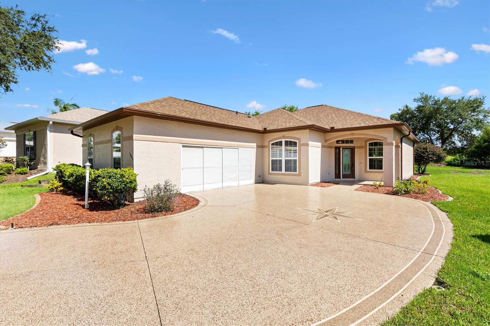 Beautiful move-in ready well maintained home on a long and quiet cul-de-sac in a 55+ gated community! This home offers tremendous curb appeal with low maintenance landscaping and a beautiful custom painted driveway (2024) which leads to a 2-car side load garage (21' x 24'). As you enter into the home through the elegant front door you are greeted with an open-concept floor plan with 10' ceilings, 2 bedrooms/2 full baths with a flex room for many uses such as dining, den, craft, study, or home office. The living room, kitchen, and flex room have tile floors and is a perfect flow to entertainment for family & friends! The eat-in kitchen includes newer appliances, a pantry, plenty of cabinet space and the kitchen has a sliding glass door to the lanai. The enclosed lanai has new carpet with natural light offering a peaceful view of the private rear yard as well as access to the beautiful newly painted patio (2024). The tranquility of the pastureland and privacy is awaiting you, perfect for morning coffee or taking a walk! The primary bedroom has a large 14 ’x 6’ walk-in closet with a professionally installed closet organizer and both bedrooms have plantation shutters as well as other windows in this extremely clean and updated home. Updates include a new roof 2022, HVAC 2022, hot water tank 2020, appliances 2023, lanai windows & door 2022, 6 windows replaced in 2022 and exterior & interior paint 2022. The garage has overhead shelving for year round storage and a recently installed interlocking floor pattern. It looks awesome! Stonecrest has many amenities to keep you busy, 1 indoor pool and 3 outdoor pools, pickleball courts, softball field, community pavilion, community center, an 18-hole private golf course, Broad Stripes Golf & Social Club Restaurant, weight room with new equipment, billiards room, shuffleboard, tennis, corn hole, bocce, numerous clubs to join and so much more! Stonecrest is just a bridge away by golf cart to The Villages where you can shop, eat, and enjoy daily live entertainment every night. Come make this your new home! One or more photo(s) are virtually staged.