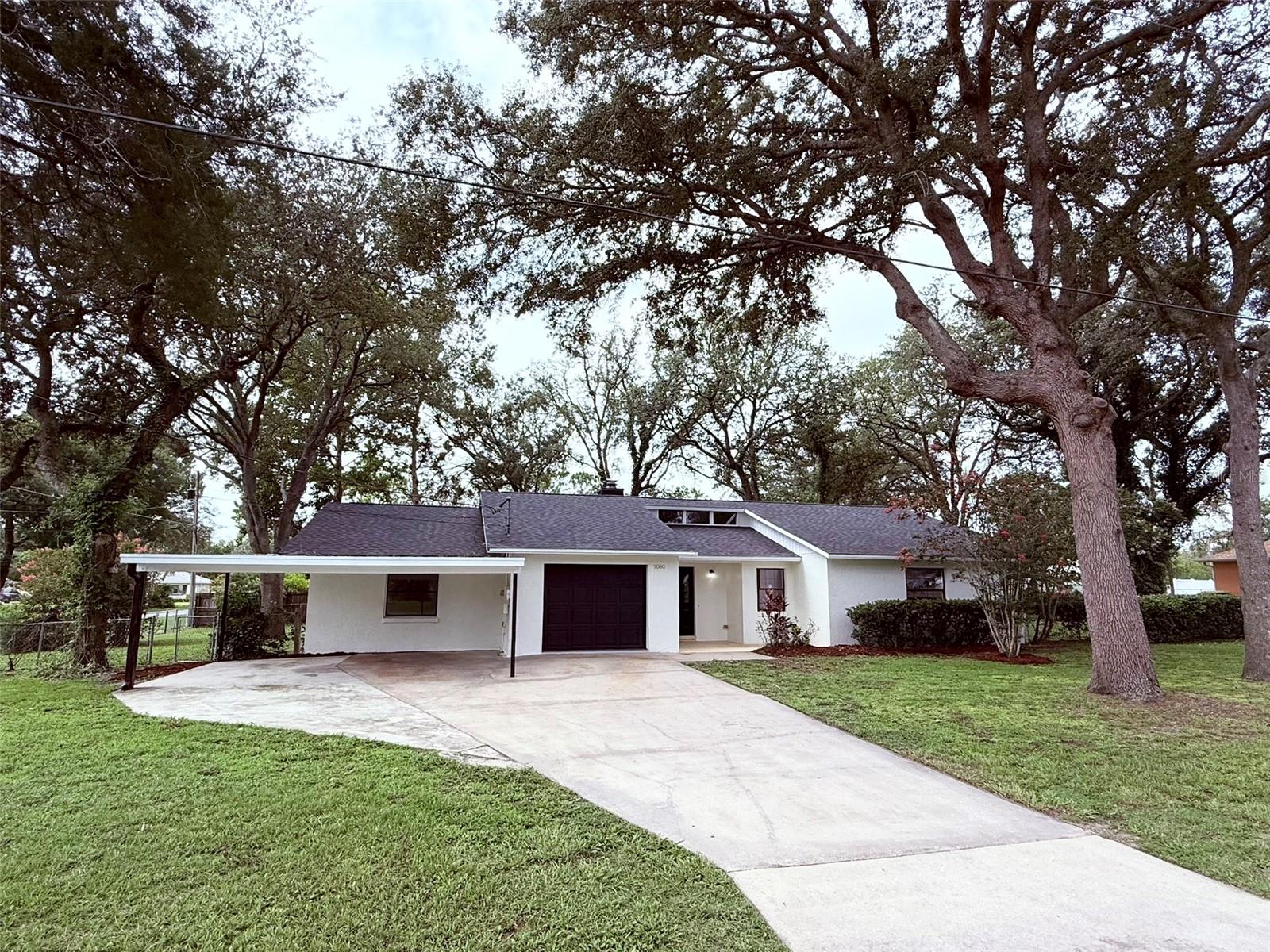 Come and see this fully remodeled beauty on an oversized lot with Oak Trees covering the property. Home features an attached IN LAW SUITE with full kitchen and bath and separate entry. Upgrades include 2 new kitchens with real wood cabinets, granite counters, and brand new appliances, new plumbing fixtures throughout, new switches and outlets, new light fixtures, new LVT, recently serviced and inspected septic system, and the list goes on and on. Don't miss out on this great opportunity.