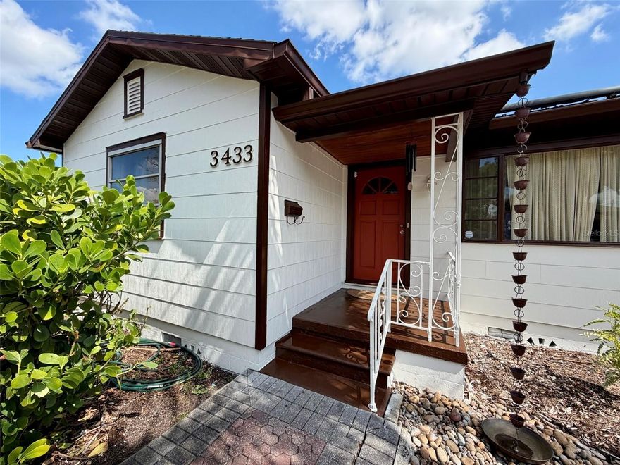 Bright and cozy Florida-style bungalow in the heart of north St. Petersburg. Located a quarter mile from I-275, 8-minute walk (2 blocks) to Kiwanis Park, 10 minute drive to Downtown St Pete, and a 20  minute drive to the gulf beaches. Roof replaced in 2017. Complete AC replacement in 2020. Original hardwood floors, lots for natural light, recessed lighting, ceiling fans in bedrooms, and an open floor plan that’s perfect for entertaining. The updated kitchen showcases marble backsplashes, quartzite countertops, full height cabinetry (with slide-out inserts), and stainless-steel appliances. The backyard includes a 6ft tall fence, sealed and stained raised deck, perimeter sidewalk, artificial turf pad for exercise or a kid’s play area, natural lawn space for sports and pets, three galvanized stock tank raised planters (includes irrigation) with  garden trellises, fruiting trees (lime, banana, and jackfruit) along with established tropical trees, palms, and bamboo providing privacy and year-round shade. The complete exterior has been recently pressure washed, sealed, and painted. Front yard is an established native Florida plant palette including sabal palms, slash pines, royal palm, and a stately live oak—creating a low-maintenance landscape that minimizes mowing and maximizes resilience.
Additional features that add long-term value, safety, and efficiency, include solar panels (lease) for reduced energy costs, whole-house water treatment system, and a brick paver circular driveway for added parking and curb appeal. Attached garage for vehicle and household storage. This house is not located in a flood zone. This property offers the perfect blend of charm, thoughtful upgrades, and outdoor living—all in one of St. Petersburg’s most convenient locations.