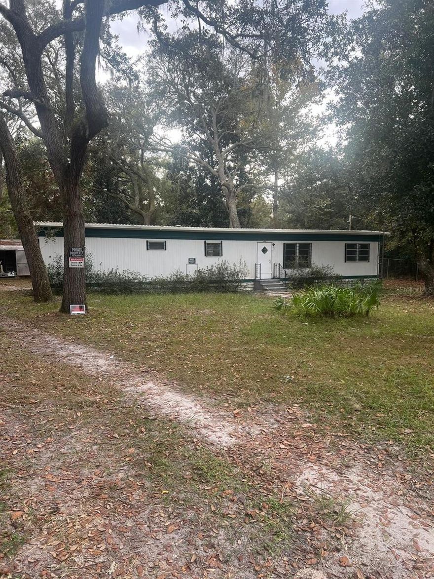Investor opportunity in desirable Northwest Ocala!

This unique offering includes a total of 3 combined lots, providing exceptional space, flexibility, and future potential. The 2-bedroom, 2-bathroom manufactured home features a large open living area filled with abundant natural light, a functional kitchen layout, and an oversized yard shaded by mature trees.

With three lots included in the sale, there is plenty of room to expand, build additional structures (subject to county approval), create outdoor living spaces, or design your own private garden retreat. Whether you’re looking to renovate and add value, hold as a long-term investment, or maximize the land potential, this property offers multiple possibilities.

Conveniently located near Silver Springs State Park, local springs, scenic trails, and natural attractions, while still just minutes from shopping, dining, and major roadways. Enjoy a peaceful setting with easy access to everyday conveniences.

Priced to reflect cosmetic updates needed. Sold AS-IS. Cash or conventional financing preferred.