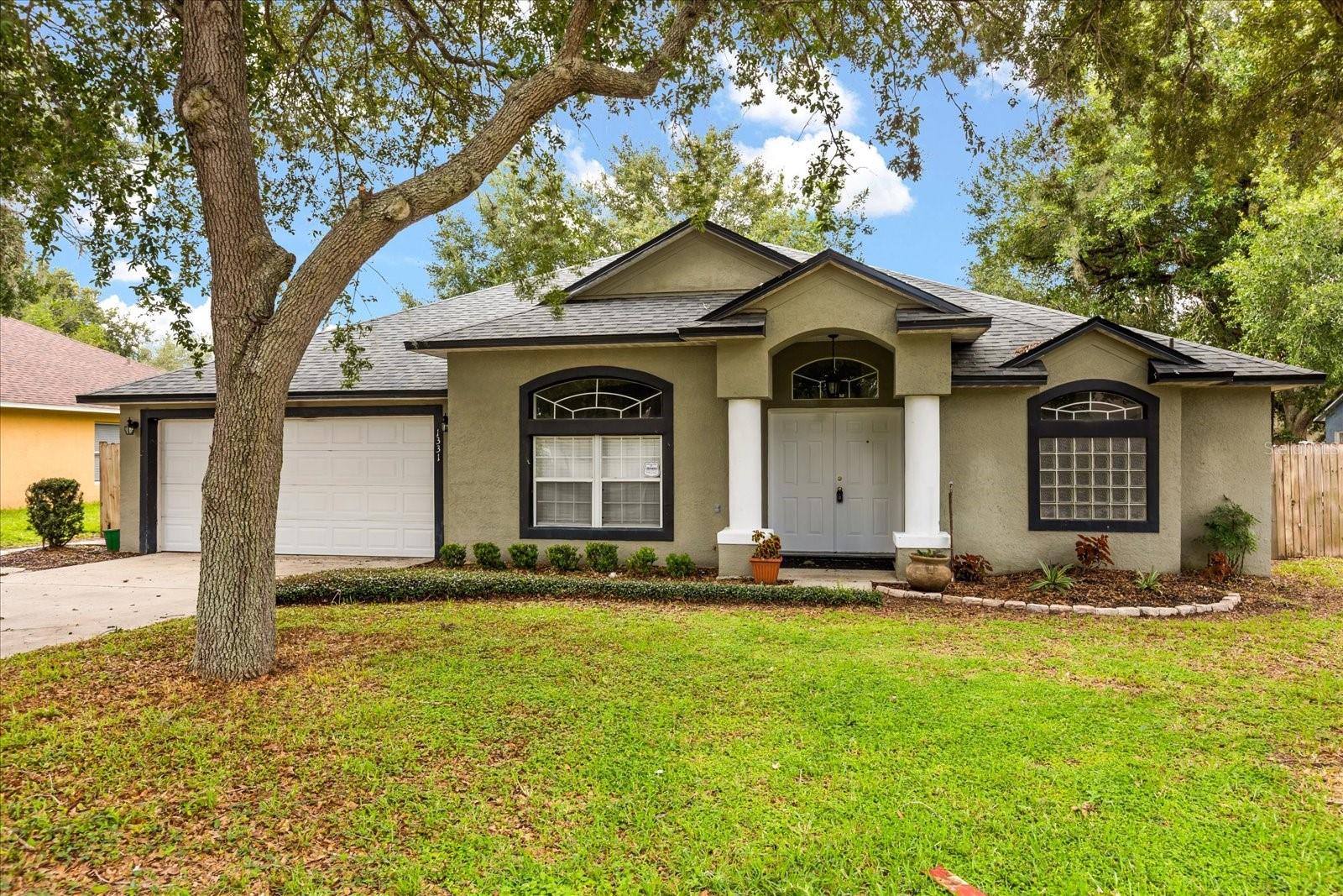 Welcome to 1331 Wildberry Lane, a thoughtfully designed 3-bedroom, 2-bath home located in the desirable, established community of Autumn Woods in Deltona. Surrounded by mature oak trees and full of curb appeal, this home offers a functional layout and a peaceful setting ideal for everyday living and entertaining — and it’s only a short 40-minute drive to the world-famous New Smyrna Beach!
Step inside to discover a split floor plan offering comfort and privacy. The generously sized primary suite is tucked away on its own side of the home and features two walk-in closets, an en-suite bath with dual vanities, a garden-style soaking tub, a separate walk-in shower, and direct access to the screened-in back porch through sliding glass doors.
At the center of the home is the kitchen — the true heart of the layout — perfectly positioned to overlook the backyard-facing living room, screened patio, and tranquil garden views. The kitchen island connects seamlessly to the open-concept living space, making it easy to entertain or simply stay connected during mealtime.
The home features multiple living areas, including a welcoming front-facing living room, a dedicated dining space, and a second spacious living room at the rear of the home with views of the private backyard and access to the screened-in porch. Each bedroom includes its own walk-in closet, and the secondary bedrooms share a full bathroom with a tub/shower combo and convenient access to the backyard.
Enjoy year-round outdoor living from the screened and covered back porch — a peaceful spot to relax under the canopy of mature oaks and watch the birds play. Additional highlights include an interior laundry room and a two-car garage.
Autumn Woods is perfectly positioned between the beach and the city — just 5 minutes from Publix, 40 minutes to New Smyrna Beach, and under 40 minutes to the heart of Orlando. Don’t miss your opportunity to own this charming home in one of Deltona’s most established communities. Call today to schedule your private showing!