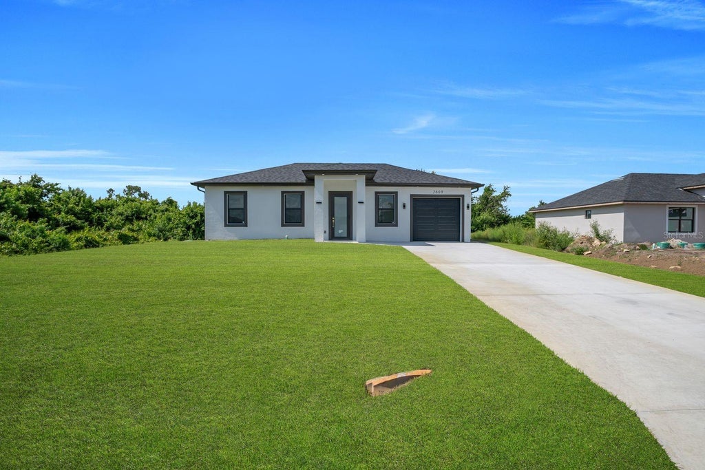 Photo of 2609 21st Street SW, Lehigh Acres, FL 33976 (MLS # A4698256)