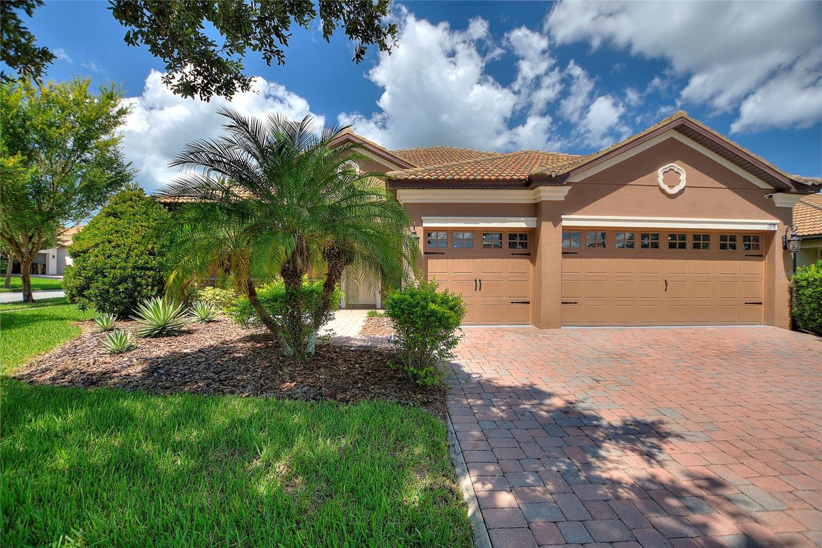 LIVE LIKE A CHAMPION! FULL GOLF AND TENNIS MEMBERSHIP INCLUDED IN HOA! Welcome to this move-in ready home in the exclusive gated community of ChampionsGate! This 4-bedroom, 3-bath, 3-car garage residence is nestled in the highly sought-after Phase 1. Walk to the neighborhood restaurant and pool! Relax on your private west-facing rear lanai, your own personal oasis, or take in views of fireworks, hot air balloons, and shuttle/rocket launches right from your driveway. Inside, enjoy upgrades like fresh interior paint, stainless steel appliances and granite countertops. The primary suite boasts a spacious walk-in shower and dual sinks. The professionally designed corner-lot features lush, meticulously maintained greenery and a sweeping front porch that exudes curb appeal. This luxury, gated, resort-style community revolves around the Oasis Club, a 14,000 sq ft clubhouse with a restaurant, movie theater, fitness center, game room, tiki bar, lazy river, cabanas, and more! The newly completed Retreat waterpark will elevate family fun, while “The Plaza” offers a resident-only clubhouse with a restaurant, bar, fitness center, game room, and pool. The HOA includes access to the Oasis Club/Plaza amenities, full golf/tennis membership, $75 food credit, gated security, complete lawn care, security monitoring, cable, phone, and internet. CDD and trash are conveniently rolled into the taxes. ChampionsGate is the ultimate location to enjoy Orlando’s theme parks, golf, shopping, and dining!