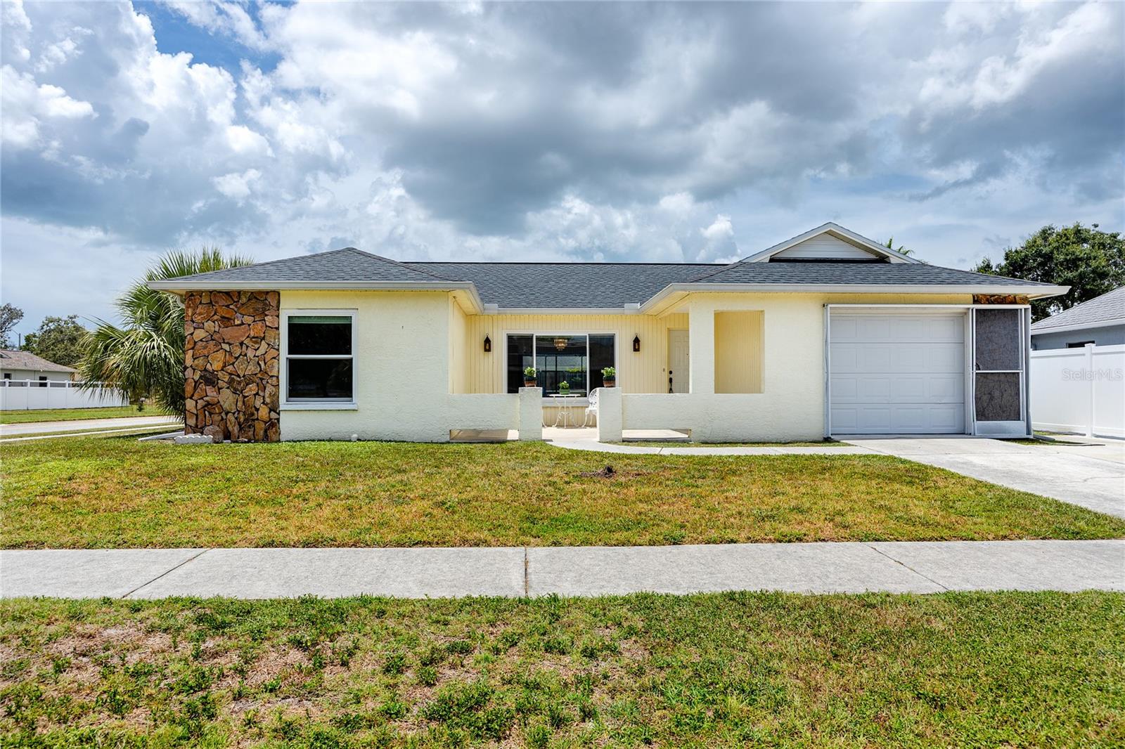 This lovely POOL HOME has NO HOA, NO CDD and is in a NO FLOOD ZONE. It's in the charming Holiday Lakes West neighborhood and blocks away from the Elementary, Middle and High Schools. All the the major ticket items have been updated within the last 5-6 years. The home boasts of a dimensional shingle roof (5 years old), hurricane rated windows(have a lifetime warranty), AC System (5 years old mol), water heater (new), water softener (six years old mol), reverse osmosis, disposal, Bosch dishwasher and the cool deck around the pool and back patio (new with 4 year guarantee). The home has painted inside and out and is light and bright. The kitchen has plenty of countertop space and a breakfast bar. The kitchen opens to the dining and family room. There is a sliding glass door from the family room to enjoy the pool view and is perfect for entertaining. The living room is spacious and can also be used as a combination formal living and dining area. There are two nice sized bedrooms with plenty of closet space. The primary bedroom has a sliding glass door that provides a private entrance to the pool area. There are plenty of closets for extra storage and the garage is an oversized for one car with extra room to add shelving for storage. The cool deck around the sparkling pool extends to the open patio where there is room to grill. The home is on a corner lot and the yard is fenced for privacy. The location is fantastic as it is a mile from Anclote River Park, the bike/walking trail, the public boat ramp, 3 miles from Tarpon Springs Sponge Docks.