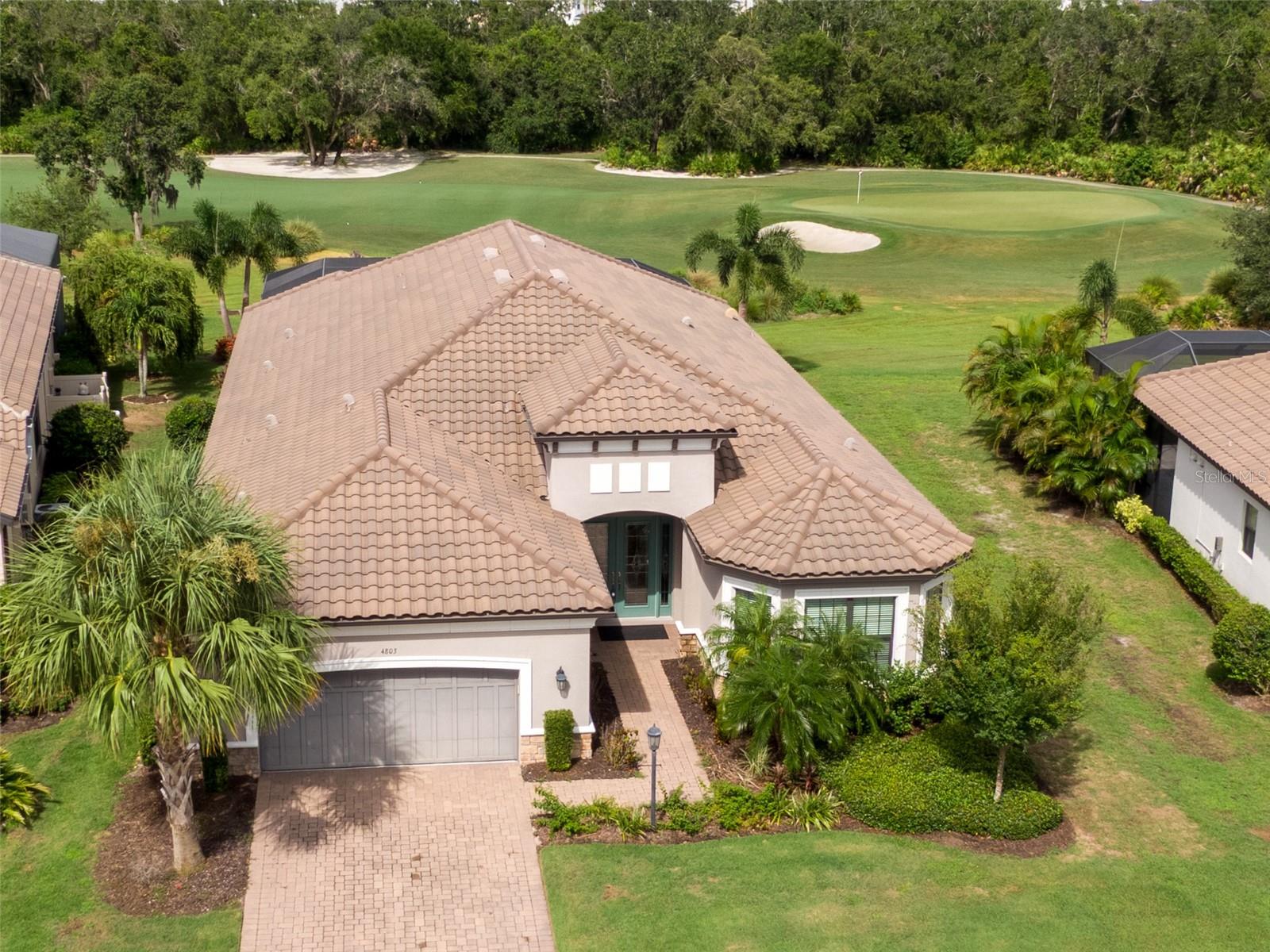 MASSIVE PRICE IMPROVEMENT! *SAVE OVER $250K* and discover Luxury Living in this meticulously maintained pool home that offers sweeping views of the 8th green, fairway and water located in the highly sought after community of Esplanade Golf and Country Club at Lakewood Ranch!
Now Offered at $1,349,000 with a 1% Lender Credit for Down Payment or Closing Cost Assistance (with our preferred lender).
This immaculate Pallazio Model Home is the epitome of sophisticated Florida living. This move-in ready 4-bedroom, 3-bathroom pool home with a private office exudes elegance and style from the moment you enter.
Step through the grand double glass doors into a breathtaking foyer where soaring high ceilings and stunning architectural details set the tone. The home is meticulously maintained, featuring hurricane windows and engineered hardwood flooring throughout, complemented by ceramic tile in the bathrooms. The tray ceilings in the living room and primary bedroom further enhance the home's luxurious aesthetic.
The chef-inspired kitchen is an absolute highlight, showcasing white cabinetry, quartz countertops, a custom tile backsplash, and premium stainless-steel appliances including a dual oven, gas cooktop, wine fridge, and ample pantry space. Open to the living and dining areas, this space is perfect for both intimate gatherings and large-scale entertaining. Sliding glass doors open directly to the screened-in pool deck, where you'll find an outdoor kitchen and awe-inspiring views of the 14th green.
The home's timeless charm is accentuated by its barrel tile roof and plantation shutters throughout, adding both sophistication and function. The luxurious master suite is a true retreat, featuring a spacious walk-in closet with built-ins and a spa-like master bath with double vanities, a large shower, and elegant ceramic tile floors.
Each of the three guest suites is generously sized, offering comfortable and private spaces, with one suite featuring an en-suite bathroom. The large laundry room provides added convenience for day-to-day living.
The outdoor living space is equally impressive, with a paver deck that wraps around the large pool (approximately 30 feet by 12 feet) – the perfect spot to relax or entertain while enjoying panoramic views of the golf course. The 3-car garage offers a tandem space for golf cart parking and additional storage.
As a resident of Esplanade Golf and Country Club, you’ll enjoy unparalleled resort-style amenities including two clubhouses, each with its own fitness center and pool, plus a main clubhouse featuring a culinary center, a heated lagoon-style pool with private cabanas, Bahama Bar, Barrel House Bistro, a full-service spa, tennis and pickleball courts, bocce ball, walking trails, and a dog park. The second clubhouse also features a resistance pool. This is a golf-deeded home, offering access to the exclusive golf course and all its benefits.
Don't miss your chance to experience the best in luxury living at Esplanade.