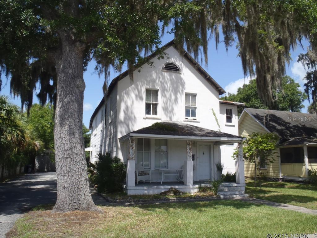 Great investment opportunity. Main house used to be old boarding house. 2 stories w/ 4-5 bathroom options and 2-3 kitchen options. Built in the early 1900s, may have historical features. In much need of repair. Back apartment has been renovated and features hardwood flooring and tongue and groove wood ceiling, nice porch and is currently occupied by tenant. Large fence backyard. Adjacent to downtown parking area and across from future site of White Challis Tabby House. Total units listed as 5 based on parcel notes in property appraiser info. Main house has new tankless waterheater and range. Apartment has refrigerator and range. ;Water: City