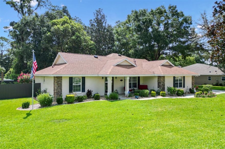 Your Private Paradise Awaits in COBBLESTONE... Resort-Style Living in this 3 Bedroom, 2 Bath CONCRETE/BLOCK/STUCCO home Minutes from The Villages, Florida!  Tucked away in a peaceful all-age community, just 20 minutes North of The Villages and 15 minutes South of Ocala, this Belleview gem feels like your own private resort. Surrounded by lush greenery and framed by a brand-new 2025 METAL FENCE, the backyard becomes your sanctuary.  Whether you’re sipping morning coffee in the enclosed lanai, grilling on the wooden deck, or simply soaking in the serenity.  Step inside and be greeted by a warm and inviting living space where a corner BRICK HEARTH GAS FIREPLACE sets the scene for cozy evenings. The split bedroom floor plan ensures privacy, while the 2022 Kitchen RENOVATION brings elegance and function together with QUARTZ countertops, Custom cabinetry, and Stainless Steel appliances.  The primary suite is pure indulgence, offering a large walk-in shower, TWO WALK-IN CLOSETS, a luxurious soaking tub, dual sinks, and private lanai access. Every detail has been thoughtfully updated, from the 2021 ROOF and 2020 GAS TANKLESS WATER HEATER to the 2023 VINYL LANAI WINDOWS and WHOLE HOUSE WATER SOFTENER system. LAMINATE and TILE Flooring flow seamlessly throughout, adding both style and ease of care.  With an extended driveway, epoxy flooring in garage and front porch, decorative curbing around landscaped flower beds, and a backyard designed for relaxation, this home offers the perfect balance of comfort and escape. Here, every day feels like a vacation yet you’re still just minutes from shopping, dining, hospitals, and entertainment.  Schedule your private showing today!