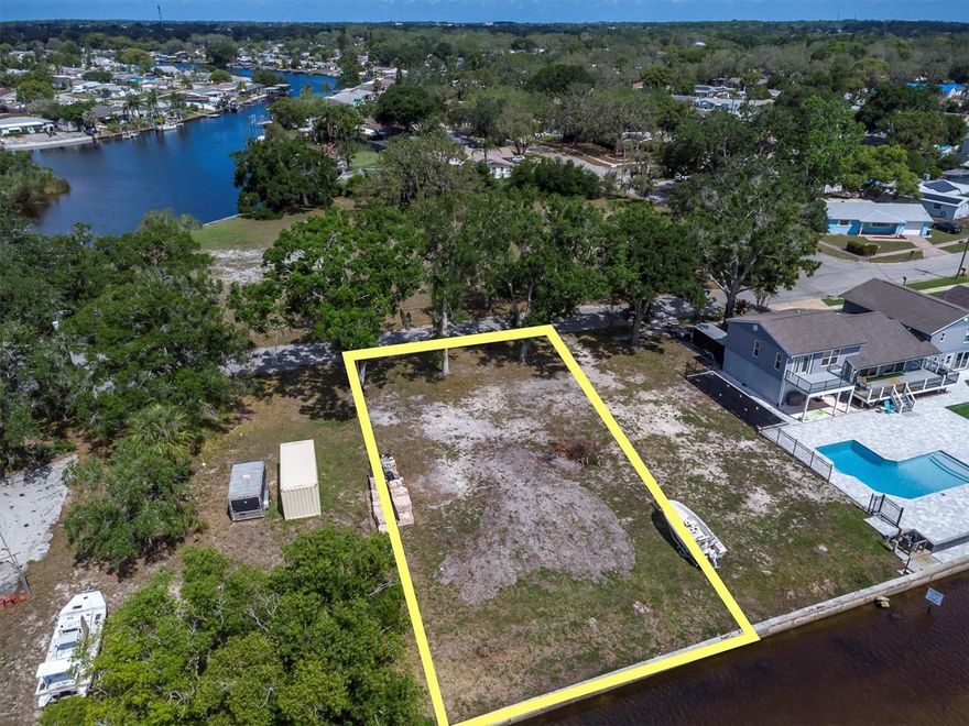 Build your dream home on this beautiful and rare .21-acre waterfront lot, ideally located on a peaceful cul-de-sac with 70 feet of water frontage, 128 feet of depth, and a seawall already in place. This build-ready property comes with a completed survey and soil test and does not require stilt construction. It’s located in an AE flood zone, but remained high and dry during recent hurricanes—offering peace of mind in your future investment. No HOA or CDD fees, and utilities are ready to go with public water and sewer available, and electric at the street. Enjoy a scenic 45-minute boat ride to the open Gulf or cruise just 25 minutes to Captain Jack’s and the famous Sponge Docks. You’ll love the natural Florida beauty in your own backyard, with dolphins, manatees, and seabirds passing by regularly. An adjacent 35-foot-wide lot to the north is likely unbuildable, giving you added space and privacy. You can even install a dock, boat, and lift without needing to build a home right away—making this perfect for immediate waterfront access while you plan your future build. This is a unique chance to own prime waterfront—reach out today and let’s make it yours.