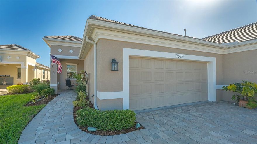 University Village built by Medallion Homes is a pristinely maintained maintenance free gated community in Sarasota with Low fees & NO CDD fees. Enjoy water views from your large extended caged patio which is also fully pre-plumbed for an outdoor kitchen. This paired patio villa has 2 split bedrooms, 2 full baths, separate laundry room and attached 2 car garage with shelving. Kitchen has solid wood cabinetry with soft close draws and cabinet doors, Quartz counter tops with ceramic tile backsplash & undercabinet lighting, custom slide out drawers for pots/pans, dimmable lighting, and stainless-steel appliances. The master bedroom has two closets and the master bath has two separate vanities with walk-in shower. Tile flooring in the main living area and LVP in the bedrooms, ceiling fans with remotes, electric fireplace on accent wall, SimpliSafe alarm system, custom clear Lexan hurricane shutters, outdoor soffit lighting and Tile roof. These original owners take pride and it shows! Home has been meticulously maintained and is in move in condition. Quarterly maintenance fees include: Landscaping, irrigation system, wi-fi and TV (spectrum), community heated pool w/spa, community center and friendly dog park. Minutes to beaches, Sarasota airport, UTC mall and downtown Sarasota.