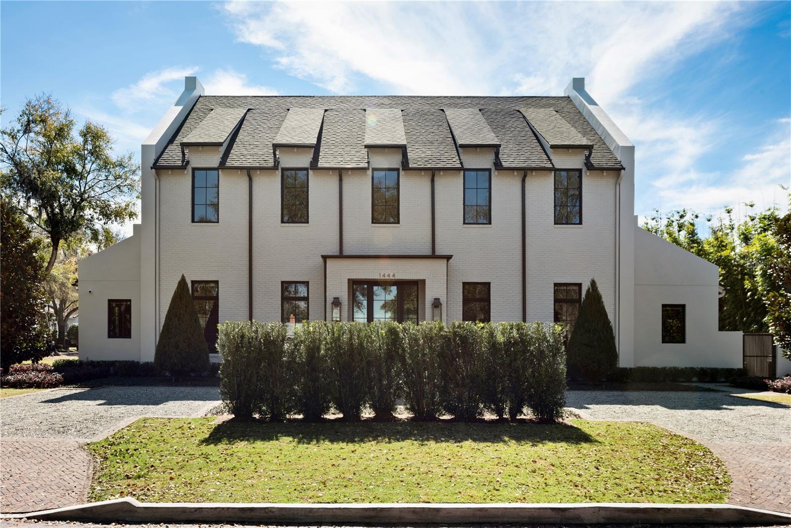 Welcome to the 2024 New construction home of the year. This English Manor masterpiece offers 6 bedrooms, 5 full bathrooms and two half baths, plus a 3 car garage. From the moment you enter this home you will be struck by the natural light, exquisite design features, and the pull of the outside/inside living. The kitchen and living room space have been designed with extreme precision and perfect symmetry offering a harmonious atmosphere for gathering. The kitchen is a chef's dream, featuring an executive cabinet collection and two islands. The main island is made from a custom rolled steel cantilevered edge ironworks and is finished with a concrete sink with a waterfall edge design. Two separate Thermador column custom panel appliances for both the refrigerator and freezer, while the Cornu Fe Blanc dual fuel gas cooktop ensures culinary excellence. The Quartzite Calcutta Matarazzo tops add elegance. Behind the kitchen is the function of the design with expansive custom cabinetry, a microwave drawer, and double refrigerator drawers; plus a washer and dryer for convenience. Two additional washer and dryer spaces are provided throughout the house. Continue to the Owner's suite which offers expansive windows, a vaulted ceiling and a Poplar succor truss beam detail. Onto the Owners bathroom the exquisite detail continues. Dual custom designed wood cabinet vanities, quartz and marble countertops, imported marble flooring in a Chevron pattern, plus premium faucets and toilets, and a beautiful floating tub overlooking the private garden. The outside offers an extension of the interior which has been pulled together beautifully by the Blue Lagos Limestone flooring in the dining, lanai and breezeway area. The outdoors offers a spacious Summer kitchen with a Wolf gas grill, Sub-Zero beverage center, custom concrete countertops, Signature designed pool, spa and sun shelf. Upstairs offers a full flex space with a wet bar and views of both the front and rear of the home. Three oversized bedrooms all on-suite, with custom built in closets. Ascending to the third floor, a private retreat awaits, with ample space for a bedroom, living room, yoga studio, ready to be personalized to your liking. Welcome home to luxury living at its finest.