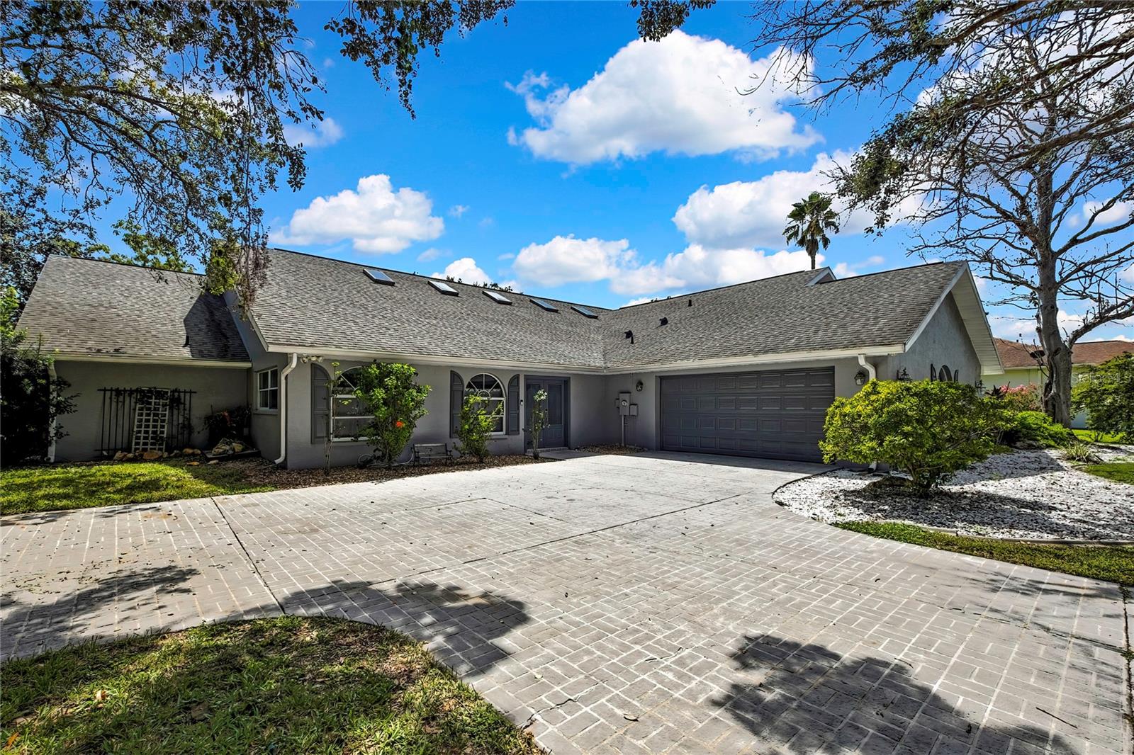 Discover your own private sanctuary in this extraordinary ranch-style home that redefines luxury living. This impressive 5,325 square foot residence sits gracefully in the prestigious Lake in the Woods Subdivision in the world renowned land of the mermaids, Weeki Wachee, FL offering an unparalleled lifestyle experience that will leave guests speechless and neighbors envious. Home is truly 5325 heated and cooled sqft including the indoor pool! (3468 sqft living area and 1857 sqft pool area)
The crown jewel of this remarkable property is the stunning indoor saltwater pool – a true conversation starter that doubles as both entertainment centerpiece and therapeutic retreat. Complete with an elegant bridge walkway and mesmerizing aquarium feature, this unique amenity creates an indoor oasis that transforms everyday living into a resort-like experience. The spill-over stone feature adds natural beauty and soothing sounds throughout your home.
With four generously sized bedrooms and three full bathrooms (including one right by the pool), including a spacious primary bedroom, this home provides comfortable accommodation for families of all sizes. The primary bathroom has a huge double shower head, walk in shower that can be very useful for homeowners with mobility issues that may require the use of a wheel chair. The huge kitchen, with two range ovens, serves as the heart of the home, perfect for creating culinary masterpieces while entertaining guests poolside.
Your expansive lot provides plenty of space for outdoor activities while maintaining privacy. The neighborhood offers an exceptional location backing up to the magnificent 11,206-acre Weeki Wachee Wildlife Preserve, where deer, wild turkeys, owls, and other wildlife provide daily entertainment right outside your door.
This secure gated community features 24-hour guard service and an impressive array of amenities including tennis courts, pickle ball, playground, dog park, community library, boat and recreational vehicle storage, scenic lake access, and catch and release fishing opportunities. The golf cart and pet-friendly environment creates the perfect family atmosphere. Lake in the Woods provides the quietness and natural surroundings of being in the woods, while still being close to everything. Shopping, medical facilities, and areas of convenience are located within minutes of the 24 hour guarded entry gate.
Smart home technology with voice-enabled features adds modern convenience to this sprawling floor plan that's much larger than street view suggests. Located outside flood zones, this storm-resilient home requires no flood insurance, providing additional peace of mind for discerning buyers. Recent updates include a 2021 air conditioning system, 2018 roof, and new water heater, ensuring worry-free ownership.