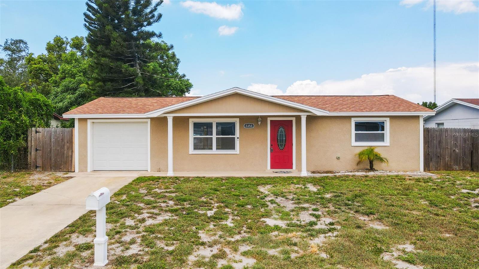2-bedroom, 1-bath home with a 1-car garage located in Holiday Lake Estates (Windows 2020 | Garage Door 2020 | Roof 2020 | HVAC 2020 ). Marked safe from the storms of 2024. Designed with a blend of modern and traditional finishes, this residence offers a spacious open floor plan. The kitchen features custom cabinetry, granite countertops, glass mosaic backsplash, stainless steel appliances, and a deep sink with a gooseneck faucet. The bathroom has been upgraded with custom tile, a granite vanity, mosaic accents, and a rain shower with a handheld wand. Additional highlights include Brazilian wide-plank wood-look tile flooring, terrazzo bedroom floors, upgraded doors, updated electrical, and energy-efficient windows. The Lennox HVAC system, water heater, and garage with a coated floor and hurricane-rated door provide peace of mind and comfort. Exterior upgrades include an architectural shingle roof, stucco, and trim accents. BONUS: screened patio and solid wood privacy fence enclosing the backyard. Don’t miss the opportunity to make this gem yours—schedule a showing today!