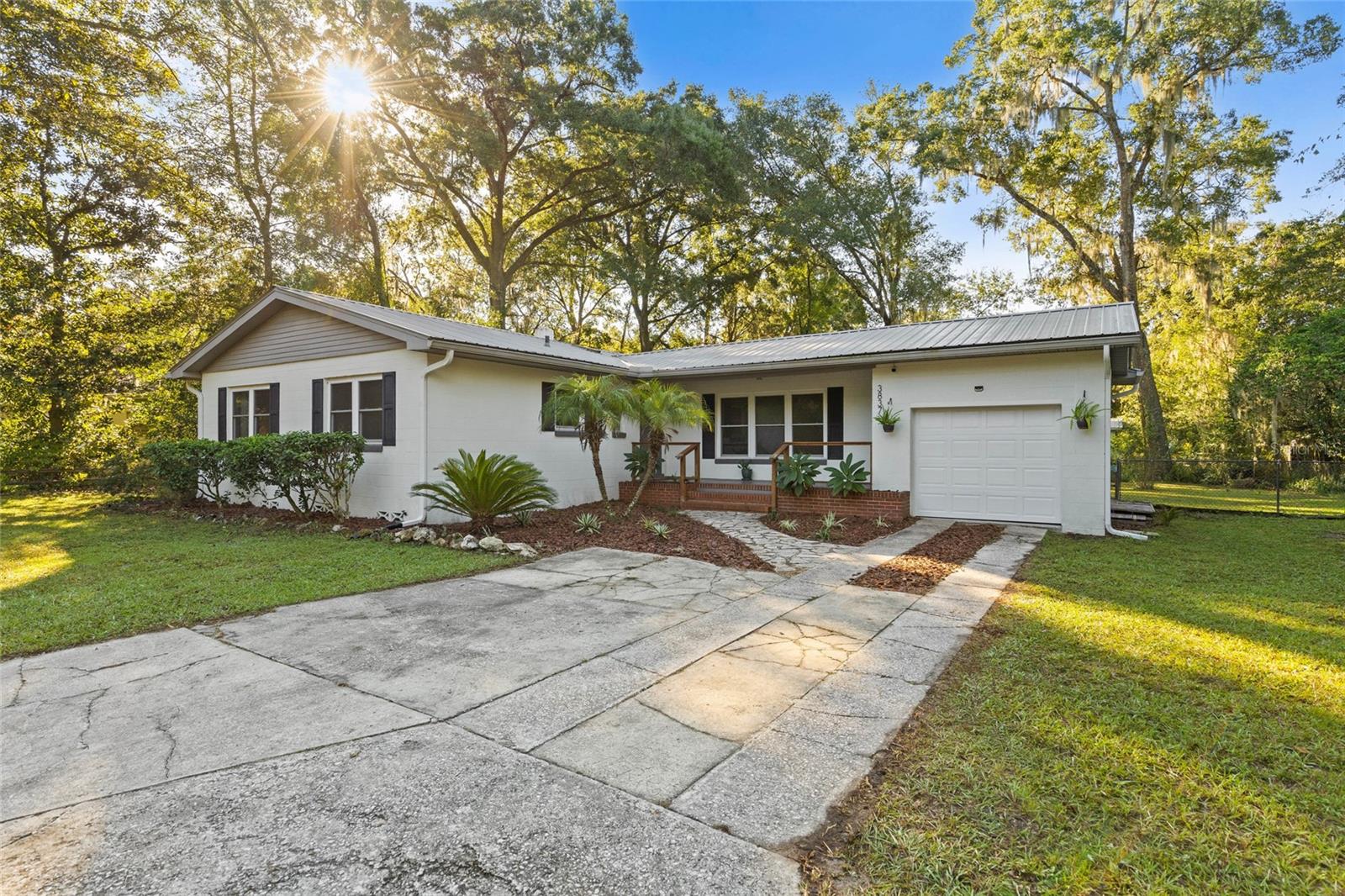 An extremely rare opportunity to own a home in the coveted neighborhood of Sugarfoot Oaks for under $300,000. This solid concrete block home features a 1 car garage and updated windows. As you walk up you’ll appreciate the fresh landscaping, and spacious front porch with built-in brick planter boxes. Walk inside, and prepare to be wowed by the hardwood floors and spacious living areas. The kitchen offers vintage hardwood cabinets, modern appliances, and a gorgeous flagstone backsplash. Three light and bright bedrooms surround the charming bathroom. The highlight of this home is the massive covered back porch overlooking the spacious fenced in yard and chicken coop. All of this in one of Gainesville’s most walk-able neighborhoods! Walk to clear lake, the community play ground, the movie theater, restaurants, grocery stores, and shops. Just a short 5 minute drive to the University of Florida. A perfect starter home, rental home, air bnb, the list goes on!