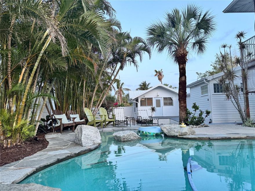 Completely reimagined 1920s historic bungalow, originally the Longboat Key Post Office, located just two blocks from Whitney Beach and one block from Sarasota Bay and public boat ramp access. This charming single-story residence is a meticulous rebuild with an open-concept great room featuring high ceilings, abundant natural light, and a gourmet kitchen equipped with stainless steel appliances and a gas range. The private, fully fenced backyard offers a heated swimming pool, separate hot tub, lush tropical landscaping, and the soothing sound of swaying palms.

Serene Village location with no public parking ensures exceptional peace and privacy. Ample boat/RV parking on site and deeded bay access steps away. Walk to Mar Vista Dockside Restaurant & Pub; minutes by car or bicycle to St. Armands Circle and Lido Beach. Offered fully furnished for a minimum 28-day rental period. Two king suites with dual closets each plus queen sleeper sofa in Main House. There is an optional one-bedroom apartment above the garage with a queen bed. Ideal snowbird retreat or extended-stay executive residence. Available now.