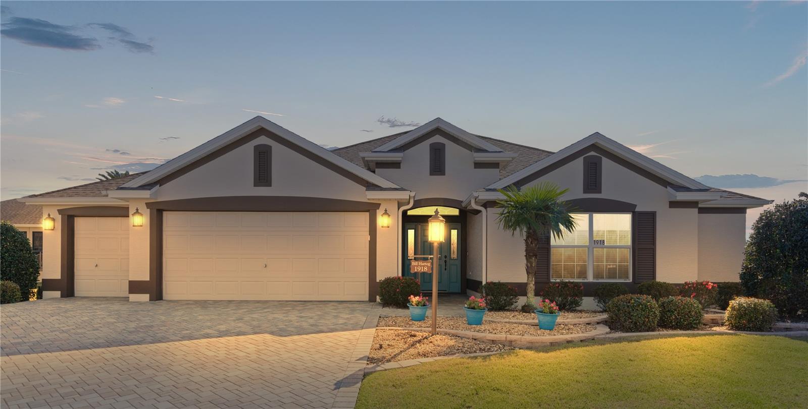BRAND NEW ROOF! NO Bond! ROOM FOR POOL! HUGE KITCHEN! OVERSIZED GARAGE with room for 2 cars and 2 golf carts! This stunning EXTENDED HOLLY model, 3-bedroom, 2-bathroom on a PREMIUM HOMESITE features CERAMIC TILE flooring throughout (except carpet in bedrooms), VAULTED KNOCK DOWN ceilings, FULL DEPTH GOLF CART GARAGE and more! The standout highlight of this home is its expansive kitchen boasting MAPLE CABINETS with a large DESK AREA, sizable breakfast bar, and separate dining area. A truly remarkable kitchen you need to experience firsthand! The GENEROUSLY SIZED living area flows into the dining area and kitchen. The master bedroom suite showcases dual walk-in closets, vaulted ceiling, and an ensuite bathroom with DOUBLE VANITIES, linen closet, separate toilet room, and a ROMAN WALK-IN SHOWER. Guest Bedroom 2 is a cozy place for your guests to relax while guest Bedroom 3 offers a beautiful front view with a large walk-in closet. The guest bath is close by with a lovely ceramic tub/shower combination. The INDOOR LAUNDRY ROOM is complete with a utility sink, built-in cabinets perfect for year-round convenience. Another feature of this beautiful home is the ACRYLIC WINDOWS ENCLOSED Lanai with TILED FLOOR and privacy shrubs. The added WINDOW SHADES are a great addition to this space. The exterior of this home boasts upgraded LANDSCAPING, updated Irrigation system, GUTTERS, PAVERED DRIVEWAY, and GARAGE DOOR and front door SCREENS. Situated in the Village of St. James, it is conveniently located just NORTH of 466A between Lake Sumter Landing Market Square and Brownwood Paddock Square. It offers easy access to EXECUTIVE and CHAMPIONSHIP golf courses, Recreation Centers, as well as shopping and dining options at Pinellas and Colony Plazas.