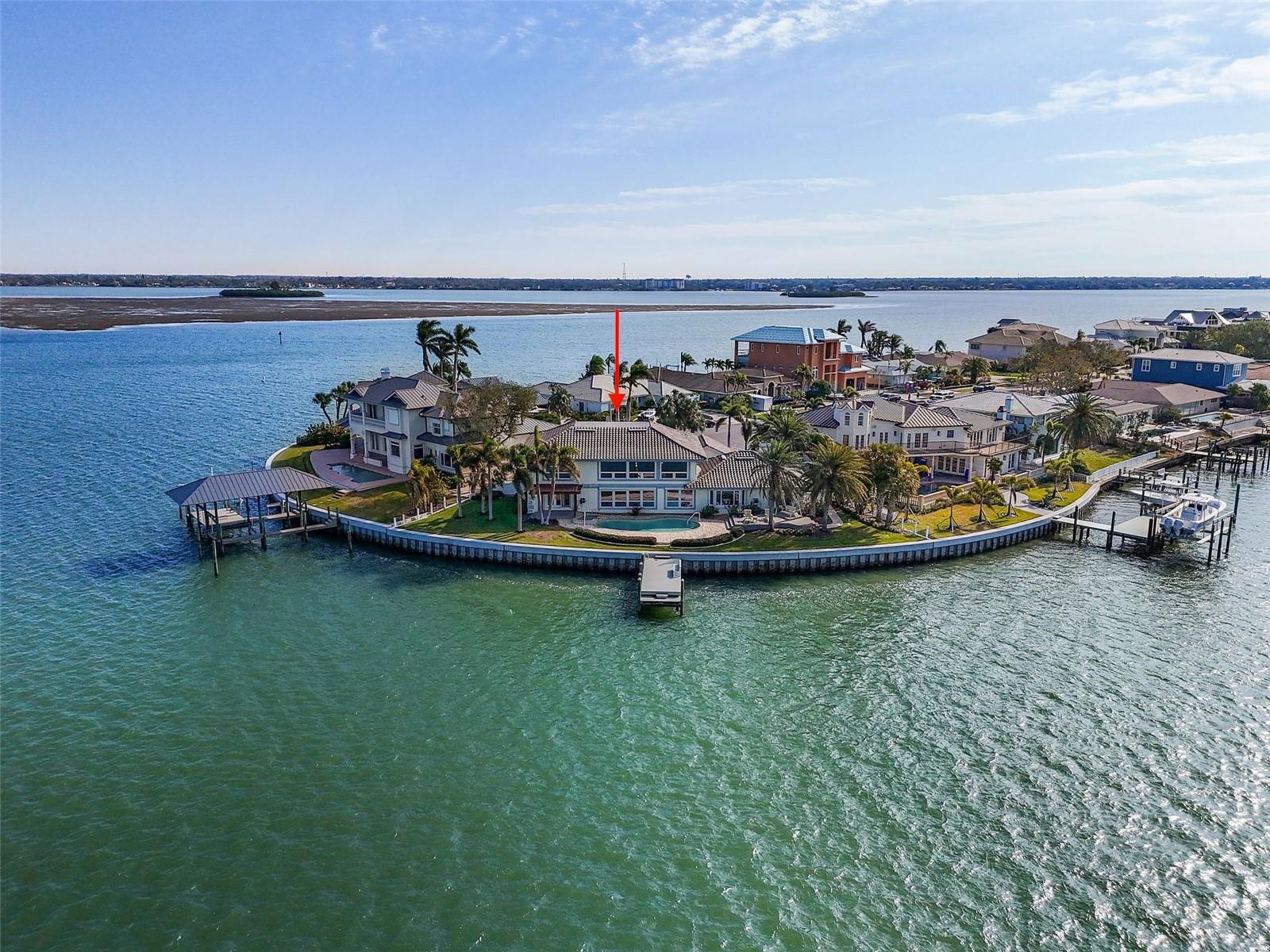 This stunning waterfront residence on Island Estates offers a once-in-a-lifetime opportunity to own one of the largest and most sought-after properties in the area. Set on a sprawling .30 acre lot with 166.5 feet of direct water frontage, the estate provides deep water access with sailboat depth and has been enhanced with a brand-new seawall, completed in 2023, that includes an additional foot of elevation—an investment of over $75,000. The existing 5,228-square-foot home offers endless possibilities, whether you choose to renovate it to your taste or tear it down and build your dream residence. Inside, expansive water views fill almost every room, creating a serene and tranquil atmosphere. The luxurious primary suite features a terrace that overlooks the sparkling waters, offering the perfect retreat. Located just minutes by boat or car from Clearwater Beach, this property provides easy access to Florida’s finest beaches, watersports, shopping, and dining. With Tampa International Airport also just a short drive away, the location couldn’t be more convenient. Whether you seek a lavish full-time residence or a seasonal escape, this exceptional estate offers the ultimate in waterfront living. This is your chance to create the ultimate Gulf Coast lifestyle—where luxury, convenience, and natural beauty come together. Home is being sold as-is. Seller makes no guarantees.