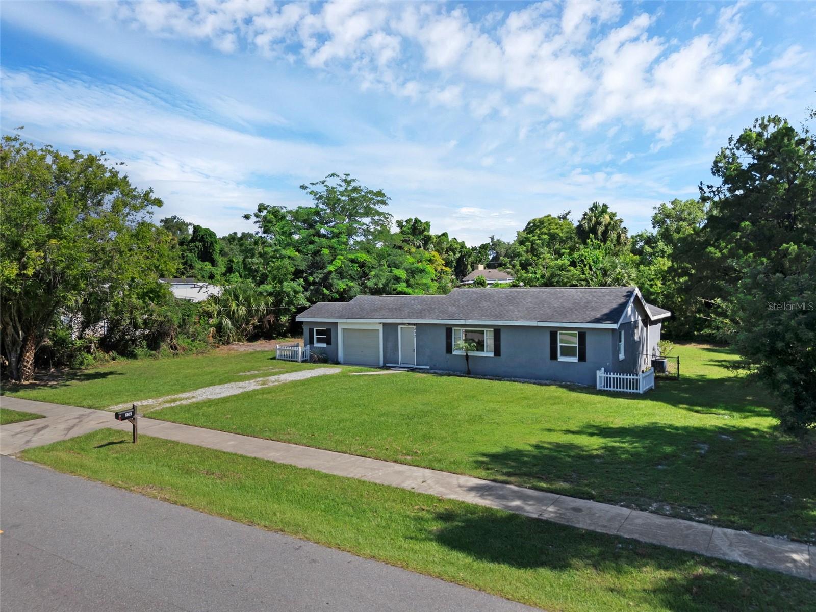 One or more photo(s) has been virtually staged. This property sits on a DOUBLE LOT that spans over half an acre! Great investment opportunity as a rental or to build your dream home! You are just minutes from the Saint Johns River public boat ramp as well as many restaurants, shops and entertainment. You are also in close proximity to the Sanford Zoo and the Sanford historic district! The home features 2 bedrooms and 2 full bathrooms with tile and wood floors throughout. The shower tiles have been updated in both bathrooms. The spacious family room offers tons of natural light and flows right into the kitchen- which is perfect for entertaining. There is also a third space located off the kitchen, which would be perfect for an office- which includes sliding glass doors that lead out to a backyard deck and backyard. The utility room is connected to the garage and has a flex space that is perfect for storage. The home has a one car garage and a HUGE backyard with NO HOA. There is a new septic drain field located in the front yard, AC is only a few years old, and the house has a new electrical panel. A new water filtration system was recently installed and the home utilizes well water. The sky is the limit for this backyard and property. Come view this today!