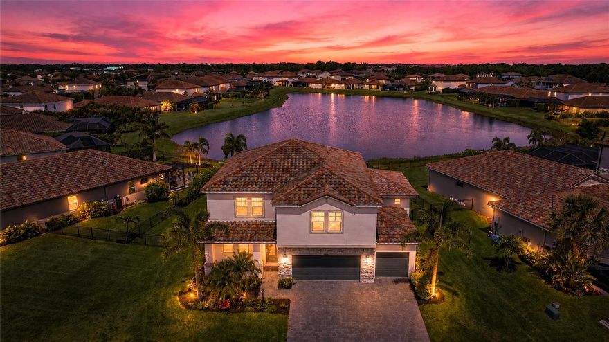 One or more photo(s) has been virtually staged. This stunning 5-bedroom, 5-bath, 3-car garage home is perfectly positioned on a premium ¼-acre waterfront lot in Lakewood Ranch—one of the nation’s top award-winning master-planned communities. Thoughtfully designed, the layout offers exceptional flexibility with spacious main living and a fully private suite ideal for guests or multigenerational living.

Step inside to a bright, open floor plan filled with natural light—perfect for both everyday living and entertaining. The gourmet kitchen is a standout, featuring quartz countertops, stainless steel appliances, a built-in gas cooktop, double oven, and a walk-in pantry. Porcelain tile flooring throughout the home adds style and durability with no carpet to maintain.

The private main-floor suite includes a separate sitting room pre-plumbed for a future kitchenette, a large bedroom with water views and direct pool access through an impact glass door, plus a full bath, walk-in closet, and its own laundry room.

Upstairs, you’ll find four additional bedrooms—including the spacious primary suite—all with walk-in closets. A large game room offers the perfect space to gather, while the primary suite provides a peaceful retreat with beautiful water views, dual vanities with quartz countertops, a walk-in shower, and an oversized closet.

Step outside to your backyard oasis featuring a custom pool and spa, covered lanai, and wide water views—perfect for relaxing or entertaining. Additional highlights include a fenced yard, smart home security system, and ENERGY STAR® certification with spray foam attic insulation for improved efficiency.

Located in the highly desirable gated community of Savanna at Lakewood Ranch, residents enjoy resort-style amenities including a clubhouse, fitness center, resort-style pool, playground, dog park, basketball court, and scenic walking trails.

Ideally positioned just minutes from A-rated schools, upscale dining, and premier shopping, this home also offers convenient access to the stunning Gulf Coast beaches of Anna Maria Island and Siesta Key—both renowned for their white sand and crystal-clear waters.