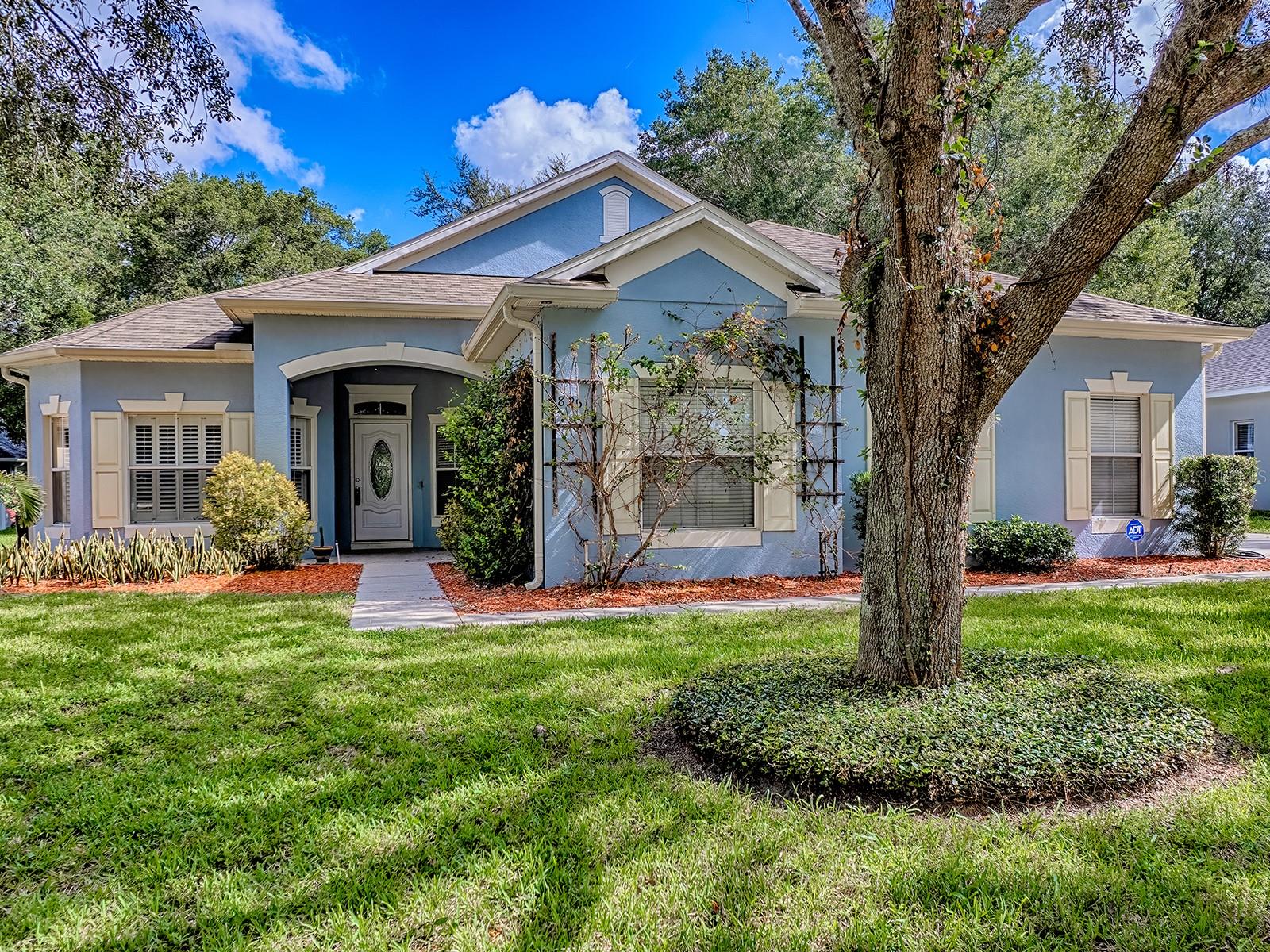 The home you’ve been waiting for – this UPDATED ONE STORY 4/2 + flex space is the perfect entertaining and family home, awaiting its next owner. The split plan with high ceilings and an open kitchen to the Great Room is perfect for today’s modern lifestyles. Upgrades include luxury vinyl plank flooring, a newly tiled master bath, granite countertops in the kitchen, and stainless steel appliances. The primary bedroom features a spacious walk-in closet complete with built-in storage shelves, offering the perfect foundation to create the closet of your dreams.
Amazing drama has been created with extensive WAINSCOTING woodwork added throughout the home. The versatile flex space can be a formal living room, office, playroom, den, exercise room, or whatever fits your lifestyle best. An oversized side-entry garage not only adds to the curb appeal but also provides extra storage and functionality.
This abode also sits on a lovely private 1/4 acre lot in the picturesque rolling hills area of Apopka—an area known for its beauty, charm, and peaceful surroundings. The upscale subdivision has tree-lined streets that keep homes nicely shaded, as well as community amenities including a sparkling pool, a playground, and a park for your enjoyment.
There are 22 solar panels on the roof that have been fully paid for, giving you a monthly electric bill of about $100 dollars. AC was replaced in 2021, and the water heater in 2022. Home is approximately 2 miles from Apopka High School and close to the 451, 429, and 414 highways. Kelly Park Springs, Wekiva Springs, and Jason Dwelley Recreational Park are nearby, and Mount Dora is just a short 20-minute drive for great shopping, dining, boat rides, and year-round festivals.