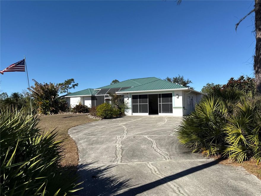 Experience relaxed Florida living in this contemporary home set on 2.3 fully fenced acres in Punta Gorda. Designed with comfort and style in mind, this three bedroom, three bath residence features an open floor plan that blends seamlessly with a spacious eat-in kitchen, creating an inviting setting for everyday living and entertaining. Step outside to your private outdoor oasis, where an in-ground pool with screened enclosure offers the perfect space to unwind or host gatherings year-round. The expansive lot provides a rare sense of privacy and flexibility, with ample room for outdoor activities and animals such as horses. Practical amenities include a two car attached garage along with a separate third standalone garage, ideal for additional vehicles, storage, or hobby use. Combining contemporary design, generous acreage, and a peaceful setting, this property offers a refined yet laid-back lifestyle with convenient access to all that Punta Gorda has to provide.