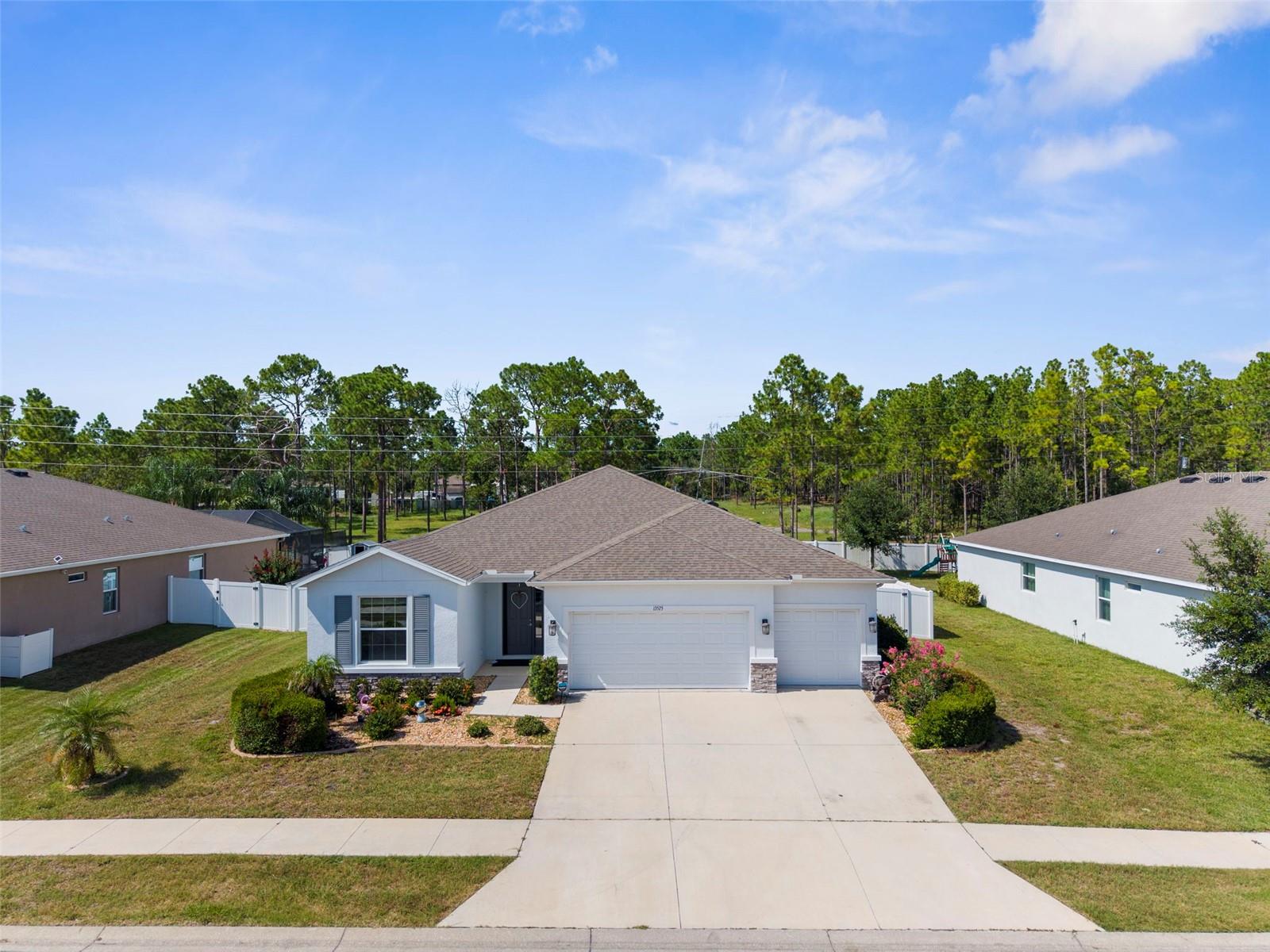 Welcome to this beautifully maintained 3-bedroom, 2-bath POOL home, located In the GATED community of Sterling Hill! Inside, the home offers a spacious, OPEN-CONCEPT floor plan with upgrades throughout. The kitchen boasts 48'' upgraded cabinetry with crown molding, granite countertops, a large center island, and is open to both the living and dining areas! The dining room features three oversized windows overlooking the pool and plenty of space for a hutch or buffet, while the living room is anchored by triple sliding glass doors that leads to the pool area. The PRIMARY SUITE is a true retreat with TRAY ceilings, brand-new carpet, and private access to the pool. Enjoy dual walk-in closets, a luxurious en suite bath with dual granite-topped vanities, oversized garden tub, and a large tile walk-in shower. A PRIVATE GUEST SUITE is located just off the living room, offering a WALK-IN-CLOSET and an EN-SUITE BATH with a stand-up shower. Two additional bedrooms are located at the front of the home, separated by a full bath with a tub/shower combo! Step outside to enjoy the in-ground HEATED POOL, complete with a screened enclosure and optional standalone Jacuzzi. Enjoy year-round swimming with a SOLAR-HEATED pool and relax in your private, fully fenced backyard, featuring attractive white vinyl fencing and lush landscaping. This home offers a range of additional features, including a brand-NEW garage door opener, GUTTERS, a NEW dishwasher, and ceiling fans throughout. The washer and dryer are optional and may convey with the sale. You'll find PORCELAIN TILE flooring in the throughout the home, as well as an extra-tall front door that adds a touch of grandeur. The DEDICATED LAUNDRY ROOM includes built-in shelving and a spacious storage closet. Outside, the Jacuzzi is optional—it can remain for your enjoyment or be removed at the buyer's request. Situated in a vibrant community, residents have access to outstanding amenities such as TWO swimming pools, a splash pad, a playground, RV storage, and a fully equipped gym. Sports enthusiasts will appreciate the tennis courts, volleyball, basketball courts, picnic areas, nature trails, and a brand-new pickle-ball court currently being constructed AND A renovated dog park is also underway!! Located just minutes from beaches, golf courses, dining, shopping, AND medical facilities, with easy access to major roads and the Suncoast Expressway (589), commuting to Tampa and the airport is a breeze! Sterling Hill offers a low HOA cost without sacrificing amenities, making it the BEST community for families, professionals, and anyone seeking both comfort and convenience. Whether you're upsizing or looking for a spacious home with room to grow, this neighborhood delivers! Be sure to watch the walk through tour vide, click ''vitrual tour''