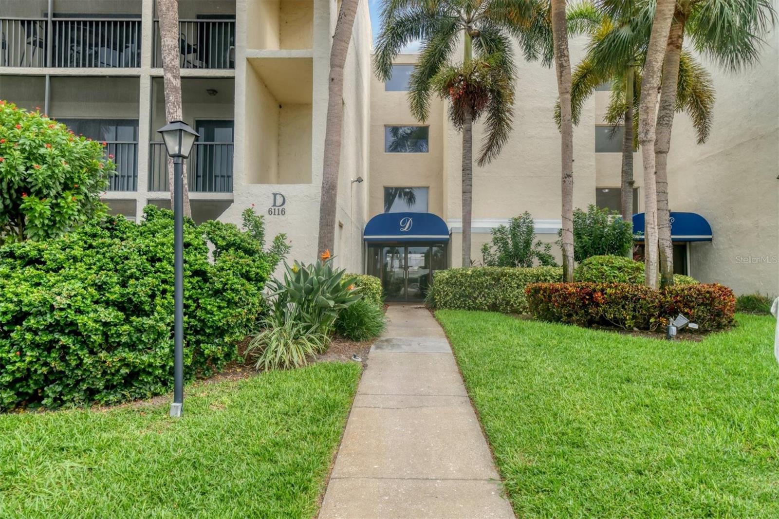 THIS PROPERTY QUALIFIES FOR A 1% LENDER INCENTIVE IF USING OUR PREFERRED LENDER! Welcome to El Conquistador Village! This move-in ready, FULLY FURNISHED condo makes life easy with its open and inviting floor plan. Offering 2 bedrooms and 2 bathrooms, it has plenty of space to relax and enjoy. The foyer includes a handy coat closet, and the dining area features a mirrored accent wall that brightens the space. The kitchen has been updated with a custom tile backsplash, herringbone butcher block countertops, a new Kohler sink and disposal, plus a Butler’s pantry for extra storage. The lower cabinets in the pantry are even movable, making it easy to access the new hot water heater.
New carpet runs through the living room and bedrooms, creating a fresh and comfortable feel. The living room opens to a screened balcony overlooking the pool, perfect for enjoying the Florida sunshine. The primary bedroom also has balcony access, along with a walk-in closet and a private bathroom featuring a glass door shower, granite countertop, linen closet, and built-in storage. The second bedroom offers its own walk-in closet and slider to the balcony, while the main bathroom includes a large vanity area with a separate shower and toilet space.
The balcony has a storage closet with shelving, plus there’s more storage available in the community’s first-floor area. A trash chute makes chores easy, and laundry rooms are located at each end of the hall. If you prefer, you can even add a stackable washer and dryer inside the unit—many owners choose the Butler’s Pantry closet for this. The building has a new roof and the condo also features a new HVAC, giving you peace of mind for years to come.
Community fees cover cable, water, and trash, adding even more value. The community pool is just a short walk away, and golf lovers will enjoy being close to IMG Academy Golf Club and Manatee County Golf Course. With Bradenton and Cortez beaches only 15 minutes away, Sarasota-Bradenton International Airport nearby, and easy access to shopping, dining, and I-75, this condo is perfectly located for both convenience and fu