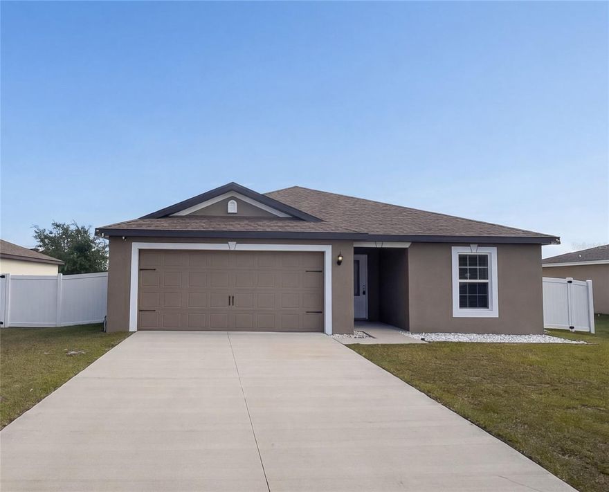 One or more photo(s) has been virtually staged. Welcome to 313 Camellia Ct in Poinciana, FL—built in 2022 and offering the feel of new construction without the wait, added costs, or hassle. This move-in ready 3-bedroom, 2-bath home with a 2-car garage is perfect for buyers seeking modern finishes, low maintenance, and affordability in Central Florida.
With 1,419 sq ft of living space, the open-concept layout seamlessly connects the kitchen and family room, creating a bright and functional space for everyday living and entertaining. The kitchen features granite countertops, 36” upper cabinets with crown molding, and stainless Steel appliances. Granite continues into both bathrooms for a cohesive, upgraded look, while vinyl flooring throughout the main living areas adds style and durability.
Step outside to a fully fenced backyard—ideal for pets, play, entertaining, or added privacy.  The spacious primary suite includes a walk-in closet and private bath, while two additional bedrooms offer flexibility for guests, a home office, or growing needs.
Low HOA and no CDD help keep monthly expenses manageable. Conveniently located near Haines City, Davenport, and major routes to Orlando, this home delivers value and accessibility.