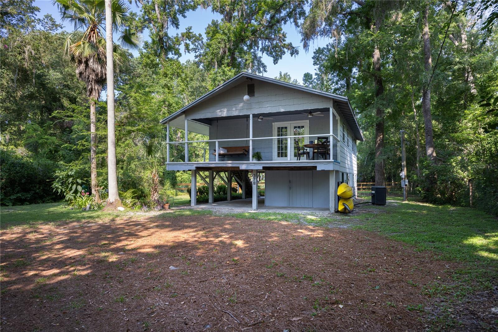 Nestled just a block away from the tranquil currents of the crystal clear Ichetucknee & Santa Fe Rivers this delightful home in Fort White, Florida offers the perfect union of comfort, natural beauty, and peaceful living. Set on almost a full acre of manicured grounds & on a paved road, this property is a true haven for those seeking relaxation & a deeper connection to nature. There is direct access to a multitude of springs which attracts an international community of divers year around.
From the wisteria covered pond to the outdoor shower & the new, large board fenced backyard this home offers the seclusion & comfort to escape to a quiet, private lifestyle. With over 2,120 sq ft including decks & downstairs, make this lovely property your own private preserve. Kitchen is galley style with built in buffet & French Doors onto the front balcony. Family room is spacious, opening into the eat-in area of the kitchen or down the hall to the bedrooms & bathroom. Downstairs is a bonus room, half bath & laundry. Great place for an additional bedroom or game room. Upgrades include but not limited to: new flooring, water filtration system, well, dishwasher, board fencing for backyard, new fixtures, painting & new roof in 2024. Even has an EV station downstairs. Home is ready for you to call your year around residence or weekend getaway - just call it YOURS!
The grounds of this home have been well manicured to create an atmosphere of tranquility & beauty. Mature trees provide ample shade & privacy, while open spaces are perfect for gardening, playing, or simply enjoying the gentle rhythms of the Florida landscape. With the Ichetucknee & Santa Fe Rivers just moments away, in this golf cart community you’ll have endless opportunities for kayaking, fishing, swimming, or peaceful riverside strolls.
This Fort White gem offers a rare combination: seclusion in nature, yet close proximity to the sparkling waters of the Ichetucknee River & the vibrant community life of north central Florida. Minimal HOA fee includes boat ramps on both rivers & access to 9 parks within the Three Rivers Community. Whether you seek adventure outdoors or a peaceful retreat, this property welcomes you home with open arms.
Don’t miss the chance to make this sanctuary your own—schedule a visit and experience the magic of river living for yourself.