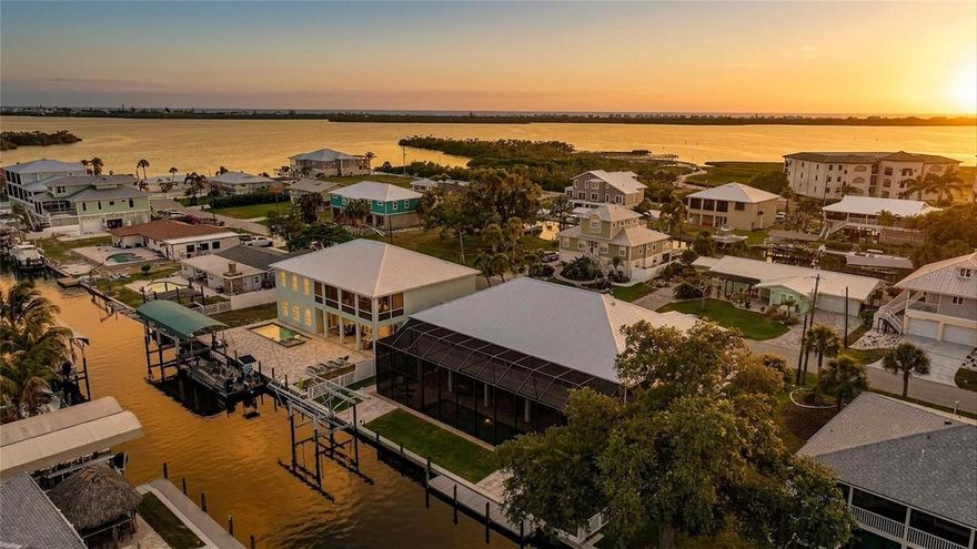 BOATER’S PARADISE — Welcome to a ONE-OF-A-KIND CUSTOM WATERFRONT ESTATE perfectly positioned on a DEEP WATER CANAL with NO BRIDGES and QUICK ACCESS to the GULF, LEMON BAY, STUMP PASS, BEACHES, AND MORE!

Completed in 2021, this ELEVATED CUSTOM HOME was thoughtfully designed for both LUXURY LIVING and PEACE OF MIND, featuring BLOCK CONSTRUCTION, IMPACT WINDOWS & SLIDERS, a METAL ROOF, composite trim, and quality craftsmanship throughout. Offering over 7,500 SQUARE FEET, this property combines spacious living with exceptional durability and efficiency and features a FULL HOME ELEVATOR for your convenience. SUPER LOW TRANSFERABLE FLOOD INSURANCE POLICY.

Inside, you’ll immediately notice the soaring COFFERED CEILINGS, crown molding, waterproof luxury vinyl plank flooring, and expansive OPEN FLOOR PLAN built for effortless indoor/outdoor living. IMPACT POCKET SLIDERS open seamlessly to a MASSIVE WATERFRONT BALCONY overlooking the HEATED SALTWATER POOL & SPA — the perfect place for a morning coffee or sunset cocktails with breathtaking sunrise views.

The CHEF’S KITCHEN features modern granite counter-tops, CUSTOM SHAKER CABINETRY with dovetail drawers, STAINLESS STEEL APPLIANCES including DOUBLE OVENS and a WINE FRIDGE, a custom WALK-IN PANTRY, over-sized island, and abundant prep space.

The spacious PRIMARY SUITE offers stunning WATER VIEWS, tray ceilings, private balcony access through French doors, DUAL CALIFORNIA-STYLE WALK-IN CLOSETS, and a spa-inspired en-suite bath with a WALK-AROUND SHOWER, DOUBLE VANITIES, and SOAKING TUB.

A secondary EN-SUITE BEDROOM also features balcony access and convenient private access near both the ELEVATOR and stairs — ideal for guests. The third bedroom offers generous flexibility as a large guest suite, office, or flex space.

Downstairs, enjoy an OVERSIZED 4-CAR GARAGE with room for a 5TH VEHICLE, EPOXY FLOORS, additional storage rooms, a FULL BATH, and a HUGE BONUS ROOM with direct access to the pool area through two sets of sliders.

Your private outdoor oasis includes a HEATED SALTWATER POOL & SPA with PEBBLETEC FINISH, TANNING SHELF, BUBBLERS, COLOR-CHANGING LIGHTS, automatic fill system, multi-level spa jets, and premium paver decking. The OUTDOOR KITCHEN features granite counters, MARINE-GRADE CABINETRY, beverage refrigerator, and stainless disposal — perfect for entertaining waterfront guests.

The FULLY FENCED backyard also includes TWO PRIVATE DOCKS with electric and water service, 100 FEET OF CONCRETE SEAWALL, plus a COVERED 10,000-LB BOAT LIFT, making this a true SAILBOAT WATER retreat built for serious boaters.

Additional upgrades include a WHOLE-HOUSE WATER FILTRATION SYSTEM, SOLID CORE DOORS, FULLY INSULATED INTERIOR WALLS, built-in GENERATOR SWITCH, circular driveway, and MORE.

Located in Englewood’s highly sought-after coastal boating community near marinas, beaches, sandbars, golf, world-class fishing, waterfront dining, and the charm of “OLD FLORIDA” living. NO HOA and NO DEED RESTRICTIONS.

Be sure to request the FEATURE SHEET and view the WALK-THROUGH VIDEO. 3D VIRTUAL TOUR is attached to Zillow Listing.

This is not a home you will want to miss. Book your showing today!