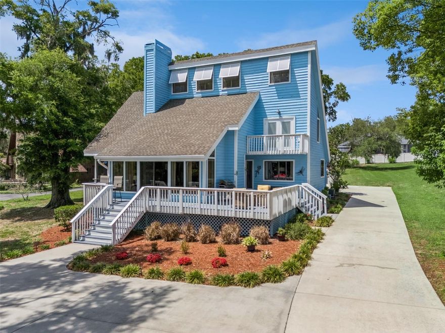 Experience the ultimate in lakefront living on the shores of beautiful Lake Louisa chain of lakes! This stunning 4-bedroom, 3.5-bath, 3-car garage POOL HOME offers 2,216 sq. ft. of inviting living space, perfectly positioned on 1.40 acres with an impressive 116' OF DIRECT CHAIN OF LAKES FRONTAGE—delivering breathtaking views right from your front yard. Designed for both relaxation and entertaining, the property features a private dock with boat lift and two separate seating areas, creating the perfect setting for morning coffee, evening cocktails, or hosting friends by the water. Gather around the fire pit under the stars and enjoy the peaceful ambiance of this one-of-a-kind retreat. Inside, you’re welcomed by a bright, open floor plan with soaring vaulted ceilings and a cozy fireplace that anchors the main living space. Luxury vinyl plank flooring flows throughout the main living areas and primary suite, combining style with easy maintenance. The kitchen is a standout featuring granite countertops, stainless steel appliances, and a built-in wine fridge. The first-floor primary suite is a true sanctuary, complete with French doors that open to the screened patio, seamlessly blending indoor and outdoor living. The en suite bath offers a spacious walk-in shower for a spa-like experience. Upstairs, three additional bedrooms and a full bath provide comfortable accommodations for everyone. Step outside to your private, fenced pool oasis with serene lake views, perfect for cooling off on sunny Florida days. The extended front porch offers yet another inviting space to relax and unwind. With a freshly painted exterior, newer roof (2016), and newer hot water heater (2024) this home is truly move-in ready and meticulously maintained. Tucked away for privacy yet conveniently located just minutes from shopping, dining, and everyday conveniences, this property offers the best of both worlds. Enjoy no HOA which offers versatility if you wanted to make this a second home and generate income through short term rental. The opportunities are endless. As an added bonus, the adjacent .55 acre lot is also available for purchase—an incredible opportunity to expand your waterfront estate or build an additional home on.  Don’t miss your chance to own this rare slice of lakefront paradise! *Aerial photo property lines are an estimate and to be verified by buyer.