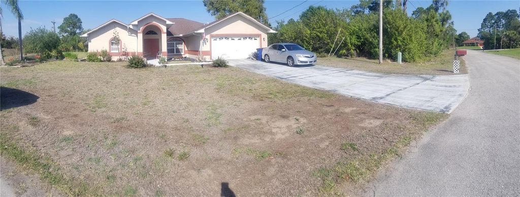 Photo of 706 Canterbury Circle, Lehigh Acres, FL 33974 (MLS # TB8501022)