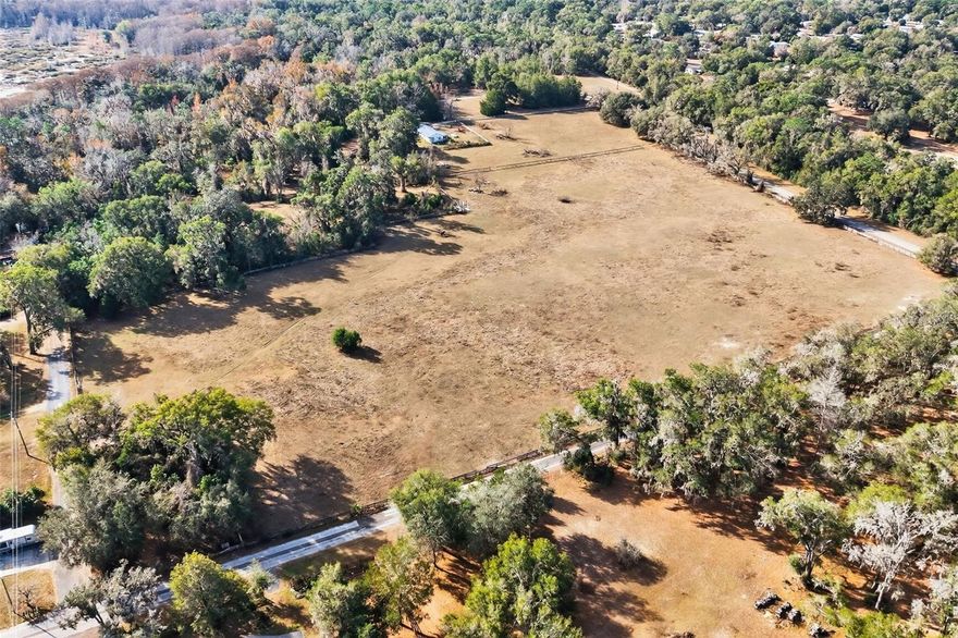Exceptional 18-Acres of land in Floral City, Florida. Discover a rare opportunity to own an 18-acre fully fenced and cross-fenced farm set on the shores of Bradley Lake in beautiful Floral City. This versatile property offers the perfect blend of peaceful country living, recreation, and functionality. Bring your animals! The property features a 3-bedroom, 2-bath home, covered carport with 1,729 sq ft, 1,953 total sq ft. The roof is a 2019. The house does need updating and needs work. Multiple wells and septic systems provide flexibility and reliability, making the land well-suited for agricultural use, livestock, or future expansion. This property has a stable with 6 stalls, (needs roof) and there is another covered stall with water and power on another part of the property. Enjoy outdoor living at its finest with a huge private pond, mature fruit trees, lake access complete with a dock and concrete boat launch—perfect for fishing, kayaking, etc. Located directly across the street from the Withlacoochee State Trail, this property offers immediate access to one of Florida’s premier biking, walking, and nature trails, adding exceptional recreational value. Whether you’re seeking a working farm, equestrian property, private lakefront estate, or a nature-lover’s paradise, this unique property delivers space, privacy, and endless possibilities in a prime Citrus County location.