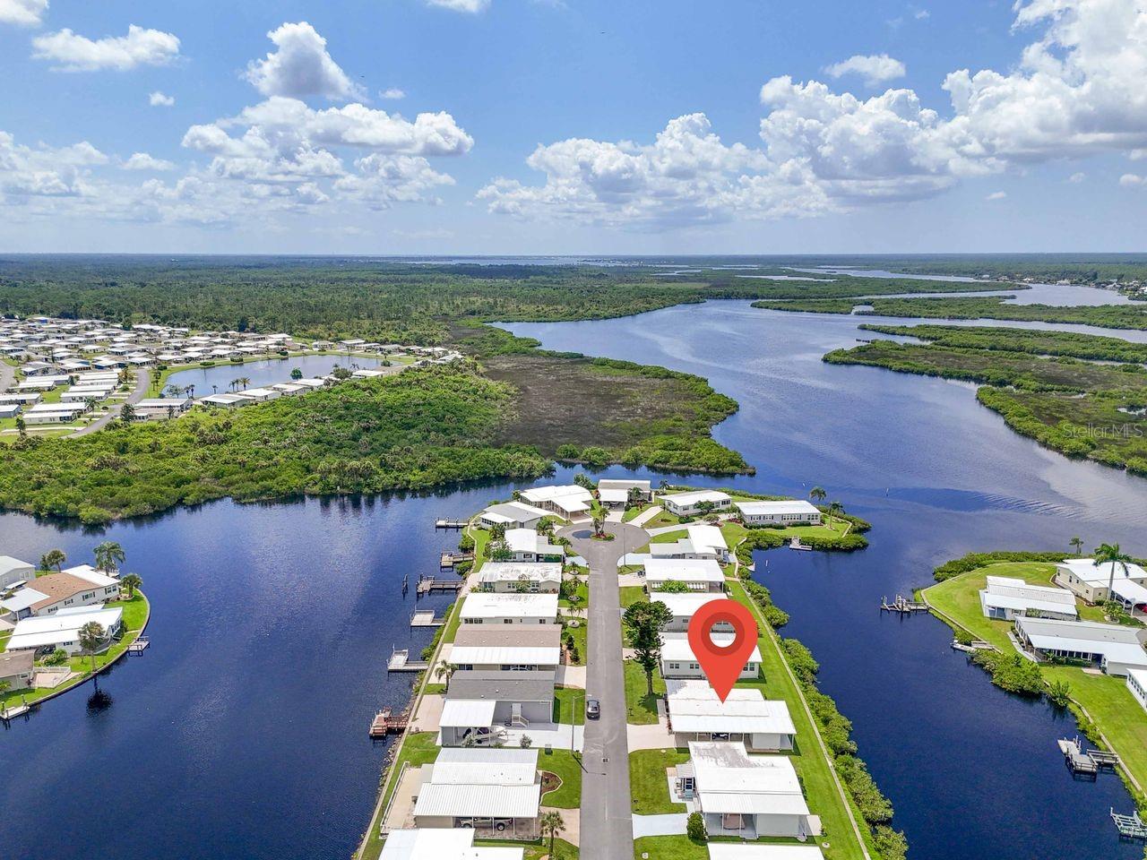 Is this the 55+ coastal inspired, CANAL FRONT, COTTAGE-STYLE HOME you’ve been dreaming of? This TURN-KEY property is in a popular WATERFRONT community along the banks of the Myakka River which features a 90-slip boat marina, the only one of its size in the area, providing access to incredible boating and fishing opportunities. This furnished waterfront, 2 bedroom, 2 bath, 960 sq. ft. home has an additional 170 sq. ft. enclosed lanai and requires an HOA fee of only $150 per month! Primarily open concept, you’ll find a nice white kitchen with newer flooring, large deep sink and a dishwasher that make clean up easy after appetizers at the breakfast bar or in the bright dining area. A comfortable living room has sliding door access to both a breezy lanai with tranquil water views and a cozy screened front porch. The primary suite has those same peaceful canal views framed by updated windows (2019), a walk-in closet, and a private bathroom with walk-in shower. The guest bedroom closet hides the newer stackable washer/dryer and is just across from the hall bathroom. Outside, enjoy the quaint screened lanai in front with a friend for afternoon tea or the open patio in back for sunset gatherings. Nature lovers with be enchanted by the wildlife sightings here daily. A new roof was installed in 2019 and a 16' x 8' shed this year. This resident-owned community provides 2 swimming pools, hot tub, pickle ball, tennis, bocce, and shuffleboard courts, a fitness center and more. Attend social events, classes, dances, holiday parades (golf cart included with sale), trivia, bingo, etc., at the 17,000 sq. ft. clubhouse. Annual boat slip rental is available for only $100! You’ll be located a short drive to beaches, restaurants, shopping, live music venues, quality healthcare and I-75. This doublewide cottage is the perfect blend of comfort, tranquility and affordability. Time to schedule a showing!