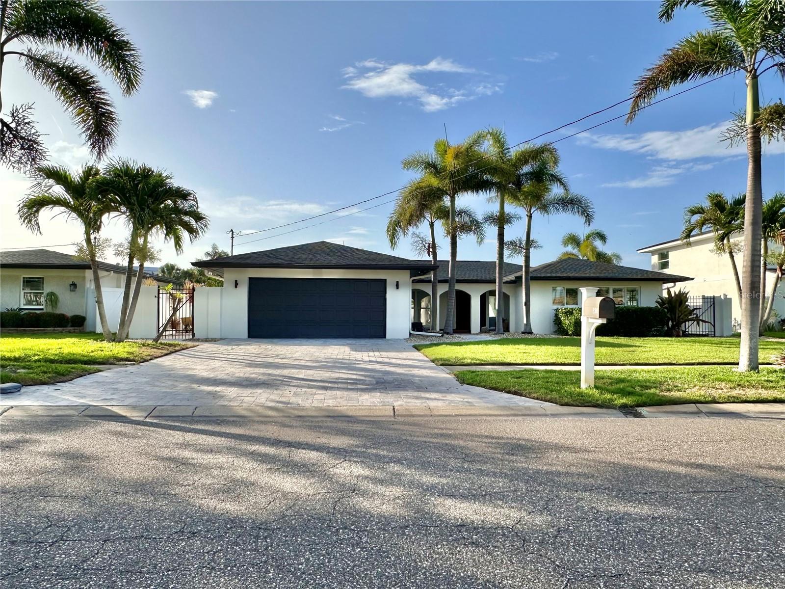 Beautifully renovated and fully furnished 4-bedroom, 3-bathroom pool home in the highly desirable waterfront community of Island Estates in Clearwater! This home features brand-new luxury vinyl flooring throughout, a spacious open layout, and a modern kitchen. It offers the perfect blend of luxury, comfort, and Florida lifestyle. The kitchen has brand-new stainless steel appliances, a large island with bar seating, and a pass-through window facing the pool and outdoor bar area. Enjoy indoor-outdoor living with a covered outdoor pool bar equipped with a built-in grill, bar seating, wall-mounted outdoor TV, and speakers for year-round entertaining. The backyard has brand new turf, a private dock with a lift that accommodates up to a 30-ft boat, and stunning water views. The master bedroom view opens directly to the pool and features a spa-like ensuite with an LED color-changing tub, his and her sinks, and a brand-new shower. The other bathrooms also include LED-lit mirrors and a hallway bath with a color-changing bidet toilet. Additional highlights include a 2-car garage, surround sound in the living room, dining room, and sunroom, a dining area that can double as a conference space with a large TV, and a bonus area that can serve as a home office or additional lounge space. With ample natural light from picture windows and sliding glass doors, this home truly captures the essence of Florida living. Conveniently located near Clearwater Beach, restaurants, shopping, grocery stores, and top local attractions, this stunning home is available now for long-term lease. Do NOT miss out!