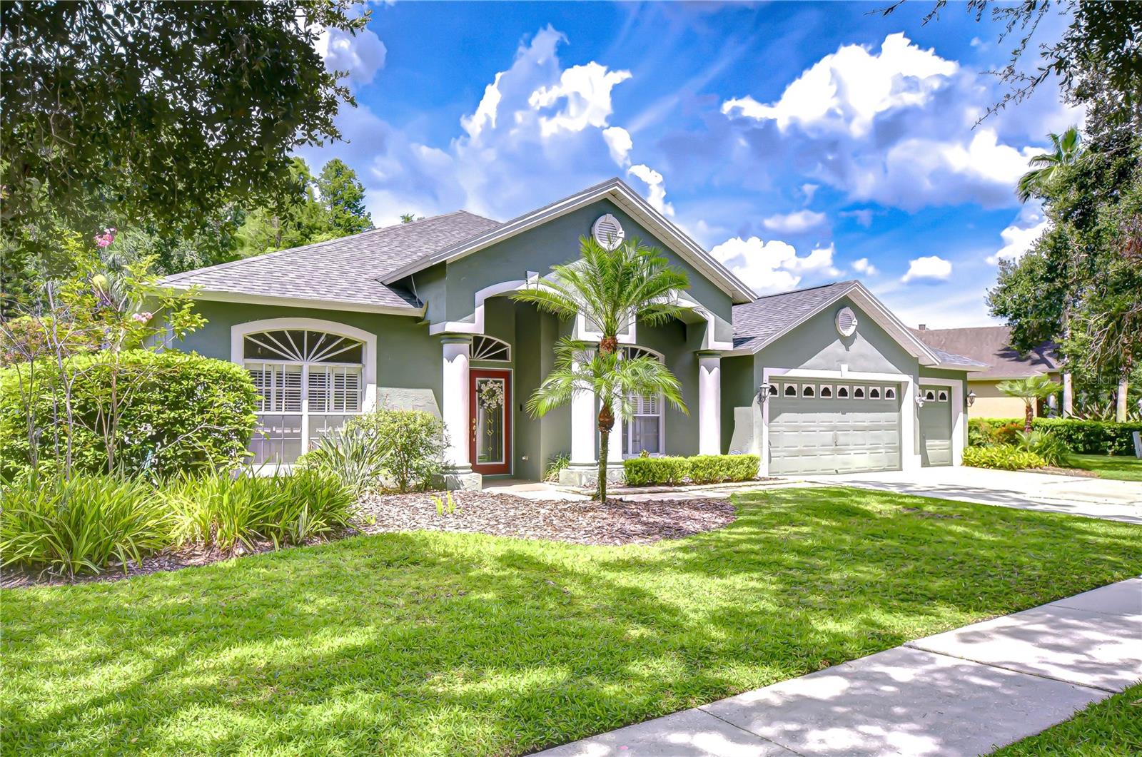 Tucked away on a quiet street in the coveted Villarosa neighborhood, this exceptional one-story home offers a rare combination of spacious living and serene natural beauty. Situated on a stunning pie-shaped premium conservation lot, the property delivers peaceful, tree-lined views and a level of privacy that’s hard to come by. With 2,907 square feet of thoughtfully designed living space, this 4-bedroom, 3-bath pool home with a 3-car garage has been crafted for comfort, elegance, and effortless entertaining. Notable updates include a newer roof (2021), A/C motor replaced in May 2024, a UV light for the HVAC system, and a generator pigtail set-up—providing enhanced efficiency, air quality, and peace of mind. From the moment you enter through the double glass front doors with a transom window above, natural light floods the interior, highlighting soaring ceilings, graceful archways, rounded corners, and a seamless, flowing floor plan. To the left of the foyer, the living/sitting room—currently used as an office—is surrounded by custom bookshelves. To the right, the formal dining room showcases refined crown molding, decorative columns, and Plantation shutters, which are also featured in the adjacent living room. The kitchen is artfully framed by a beam-topped colonnade, adding architectural character while subtly defining the space. This eye-catching kitchen features framed cabinetry with rope detail, Granite countertops, a tumbled marble backsplash, a center island, and a casual dining space. The breakfast bar lies beneath the beam structure outlining the kitchen, and opens to the expansive great room where a built-in entertainment wall is bathed in natural light from the triple sliding glass doors and transom window above, leading out to the lanai. The luxurious primary suite, entered through double doors and finished with crown molding, offers tranquil views of the pool and conservation area through sliding glass doors. It includes dual walk-in closets and a spa-like ensuite bath with separate vanities (including a dedicated makeup area), a tile surround soaking tub, walk-in tiled shower with glass block detail, a linen tower, and a private water closet. The secondary bedrooms are generously sized, with ample closet space. One features its own ensuite bath with direct access to the pool, perfect for guests or multigenerational living. Step outside to the show stopping outdoor living area—where a screened lanai, sparkling pool, and spacious patio invite year-round enjoyment. Backed by conservation with no rear neighbors, the backyard feels like a private retreat. Located in one of Hillsborough County’s top-rated school districts—including Steinbrenner High School—this home combines natural serenity with everyday convenience. Shopping, dining, and major commuter routes are just minutes away. Residents enjoy access to nearby Villa Rosa Park, a scenic 7-acre space featuring a playground, tennis courts, sand volleyball, basketball, picnic shelters, restrooms, open green space, and walking trails. With easy access to the Veterans/Suncoast Expressway, Tampa International Airport, downtown Tampa, medical facilities, top-rated golf courses, and entertainment venues, this location is ideal. Don’t miss your chance to live in Villarosa—one of Lutz’s most desirable communities. Schedule your private showing today!