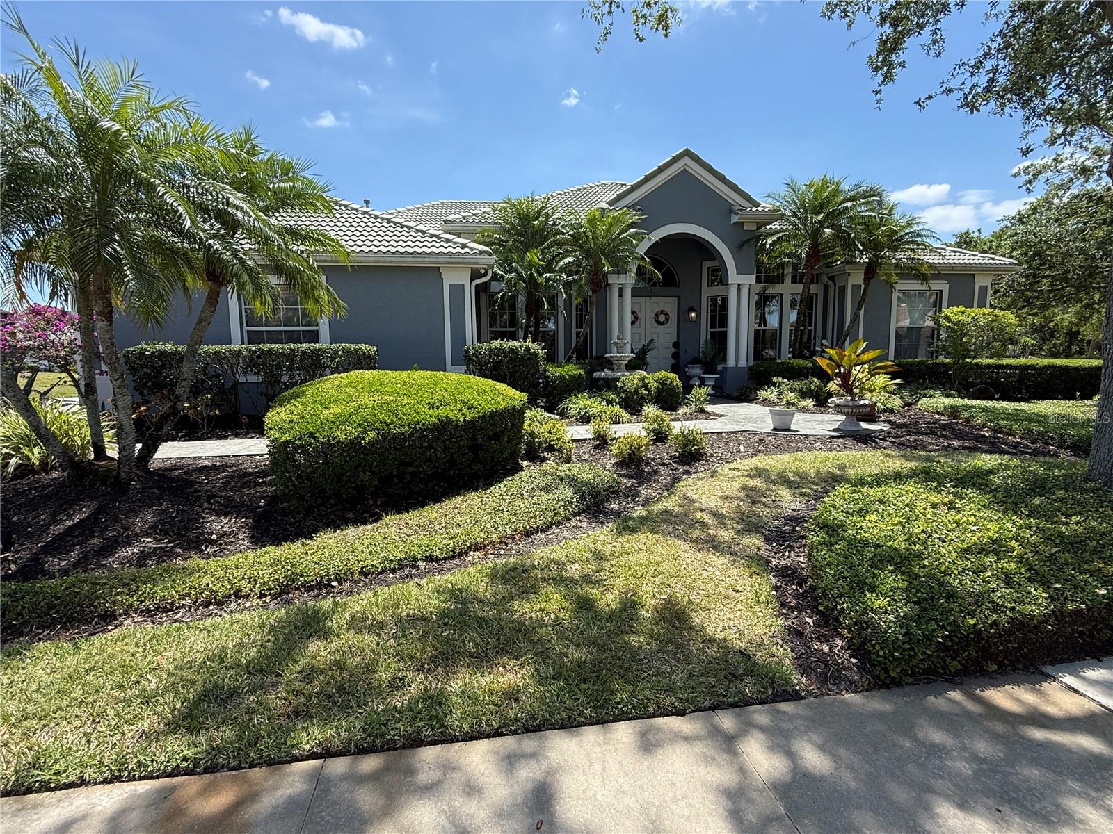 ***HOA Rule Minimum of 6 months *** Enjoy stunning water views and peaceful living in this STUNNING one-story custom home, ideally located on a quiet cul-de-sac in the Sanctuary at River Club. Just under a half-acre, this three-bedroom, three-bath home offers one of the most breathtaking homesites in the community. An open and elegant floor plan features soaring ceilings, detailed trim work, and a formal living and dining area that welcomes you through double entry doors. The great room impresses with disappearing cornerless sliders leading to the screened-in lanai, a wood-burning fireplace, tray ceilings, and crown molding. The kitchen is a chef’s dream, offering marble countertops, a walk-in pantry, abundant cabinetry, a 6-burner dual-fuel GE Monogram stove, a stainless-steel refrigerator, and an oversized breakfast bar. A cozy breakfast nook with a window overlooks the serene lake and heated pool surrounded by travertine pavers. The owner’s retreat includes two custom walk-in closets, a stone accent wall, bay windows, direct lanai access, and a luxurious bath with dual vanities, a soaking tub, a separate shower, and a private water closet. Two guest suites are situated on their own wing, one with a private en-suite bath. An executive office with built-ins, a built-in sound system, and a rare side-load driveway and garage add to the appeal. No smoking is allowed in the home or garage. All within a deed-restricted, non-mandatory membership golf community. Easy to show...Call today!! ***March - October monthly rental rate $6,500 | November - February $10,500 monthly rental rate.