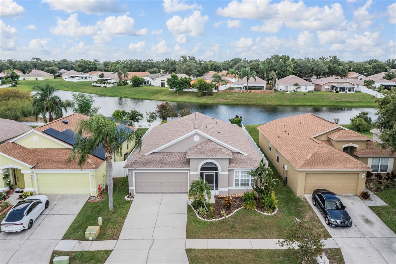 Welcome to this beautifully maintained Destiny model home, perfectly situated on a sparkling pond and surrounded by lush, professionally landscaped palm trees. Featuring 4 bedrooms, 2 bathrooms, and a 2-car garage, this property offers the perfect blend of style, comfort, and value, with no CDD and low HOA fees!
Step inside to find vaulted ceilings, a thoughtful layout, including a formal living and dining room combo, plus a separate family room that has triple sliders that open onto the expansive screened lanai. The fenced backyard provides a private retreat for relaxing or entertaining while enjoying serene waterfront views.
The spacious eat-in kitchen comes complete with a built-in desk area, pantry, and plenty of natural light. The master suite offers a walk-in closet and a spa-like bath with a garden tub and separate shower.
Don’t miss the chance to own this move-in-ready waterfront gem—schedule your showing today!
