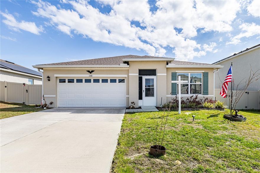 Discover your ideal home in the heart of Tavares, Florida, a charming community known for lakeside living, outdoor recreation, and convenient access to local amenities. This 2022-built smart home offers thoughtful upgrades, modern features, and the perfect blend of comfort and style.



Step inside through the inviting enclosed entryway into a bright and open floor plan with smart home technology and contemporary finishes throughout. With 3 bedrooms and 2 baths, this home was designed with both everyday living and entertaining in mind.



Outside, enjoy a beautifully landscaped backyard oasis — completely fenced for privacy with a lush hedge and a charming corner flower garden. Dual side gates give you easy access to both sides of the property, ideal for pets, projects, or outdoor gatherings. This peaceful backyard space is perfect for relaxing evenings or weekend barbecues.

Location is truly a highlight. You’ll be just minutes from everyday conveniences including shopping, restaurants, the YMCA, the hospital, and the Lake County Courthouse in downtown Tavares, giving you effortless access to government offices and services.



Living in Tavares means enjoying small-town charm with big lifestyle perks — proximity to lakes, parks, community events, and a growing local scene make this a desirable spot for buyers seeking both convenience and tranquility.



This move-in-ready home combines newer construction with a prime Lake County location — schedule your private tour today!