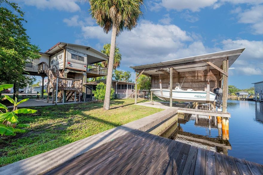 Escape to the laid-back lifestyle of Suwannee, FL with this charming 1 bedroom, 1 bathroom home nestled along a fresh water canal with direct access to the renowned Suwannee River. Perfect for weekend getaways or full-time living, this elevated home features a private boathouse complete with a boat lift—making it a dream spot for boating and fishing enthusiasts. Enjoy peaceful mornings or relaxing evenings in the spacious screened-in room under the house, ideal for entertaining or simply soaking in the coastal breeze. Whether you're exploring the river, watching wildlife, or just enjoying the tranquil setting, this property offers a unique opportunity to own a piece of Florida’s hidden gem.