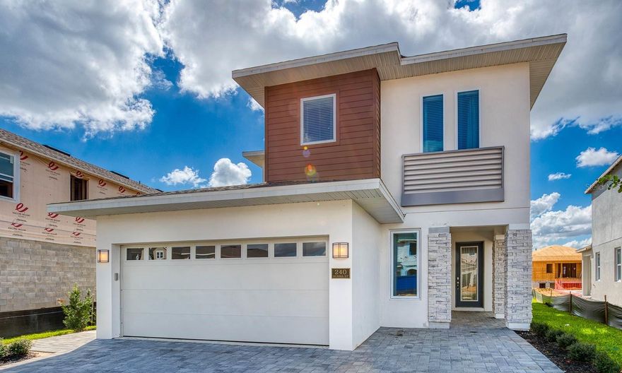 Discover this modern vacation residence showcasing a sleek exterior design and an impressive private pool area that sets the tone for indoor–outdoor living. The home welcomes you with a bright and open main living space, highlighted by an oversized great room with abundant seating ideal for gathering, relaxing, or entertaining after a day at the parks. The contemporary kitchen features stainless steel appliances, extensive granite counters, a three-seat breakfast bar, and an adjacent dining area that comfortably accommodates eight.
The second-floor loft extends the home’s entertainment options with a wall-size Scrabble board, air hockey table, and mounted flat-screen TV, offering a dedicated space for guests of all ages.
Four well-designed bedrooms provide comfortable accommodations for up to eight guests. Two Queen suites, a King suite, and a themed bunk room each offer plush bedding and flat-screen TVs. Bathrooms are thoughtfully finished with dual sinks, large showers, and modern fixtures.