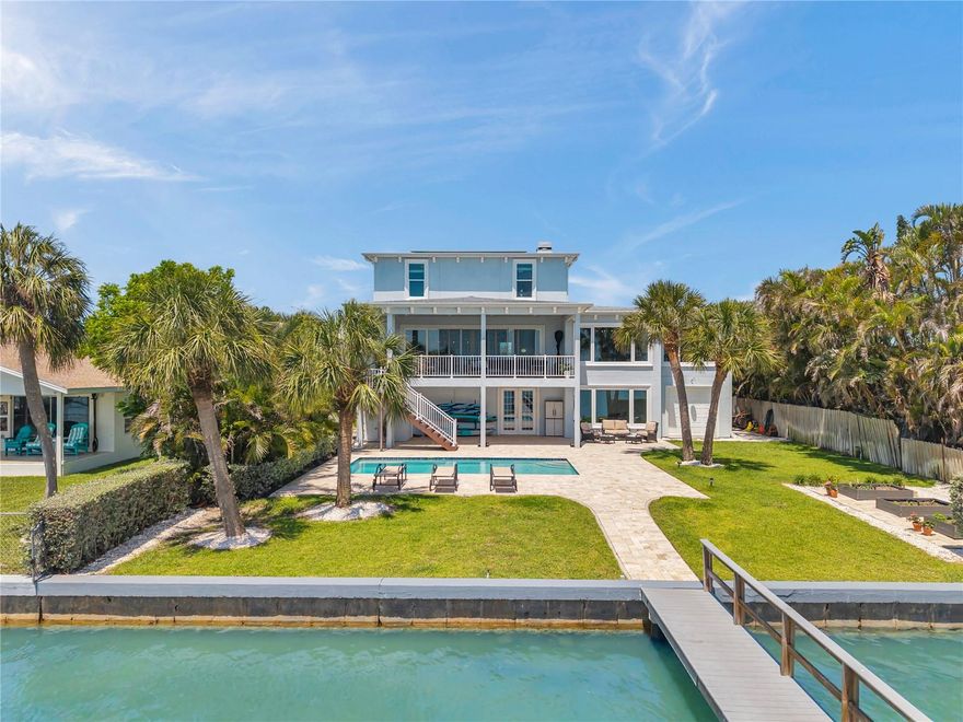 Exquisite modern waterfront masterpiece just a short 15-minute stroll to the beach! Built in 2018, this 3-story custom home sits on an oversized lot and perfectly blends high-end craftsmanship, energy efficiency and breathtaking panoramic water views.

Enjoy sunrises each morning from your expansive covered balcony or pool-level lanai, and colorful sunsets from the end of your private 72-foot Trex dock—lift-ready with 50-amp service. Inside the home, handscraped hardwood floors flow through open concept living spaces. Wall-to-wall impact-rated sliding glass doors to the balcony provide spectacular water views, while the wood-burning fireplace, gleaming granite wet bar, and crown molding are also worthy of attention.

The GOURMET KITCHEN boasts DOUBLE OVENS, solid-wood cabinetry, gorgeous quartzite countertops, and an oversized center island. Other highlights include a new 5-burner glass cooktop, new dishwasher, a reverse-osmosis water filtration system, large walk-in pantry/laundry room, and a full-size wine fridge.

The primary master suite is larger than life and a true sanctuary: sweeping water views, spa-worthy bath with jetted tub, oversized shower, marble vanities, and a chandelier-lit walk-in closet. The other 2nd floor bedroom with private balcony is used as an office, while three additional bedrooms on the 3rd floor offer equal elegance.

Luxury extras include an ELEVATOR, paid-off SOLAR PANELS, whole-home and backyard AUDIO system, premium water softener, new water heater (2025), and insulated STEEL CONSTRUCTION for superior strength and LOW ENERGY COSTS. The oversized 4-car garage offers three EV chargers, a GENERAC switch, and plenty of room for a gym and entertainment options. LOW FLOOD INSURANCE is approximately $600 per year, and energy bills over the past year have been as low as <$40/month. 

Located on a quiet street in one of St. Pete Beach’s most desirable waterfront neighborhoods (no HOA), you’re steps from local dining, shopping, the Corey Avenue Market, evening concerts and events in Horan Park, and minutes to vibrant downtown St. Pete and major airports.

This is a rare opportunity to own a one-of-a-kind coastal retreat where every detail blends beauty, function, and the best of Florida living.