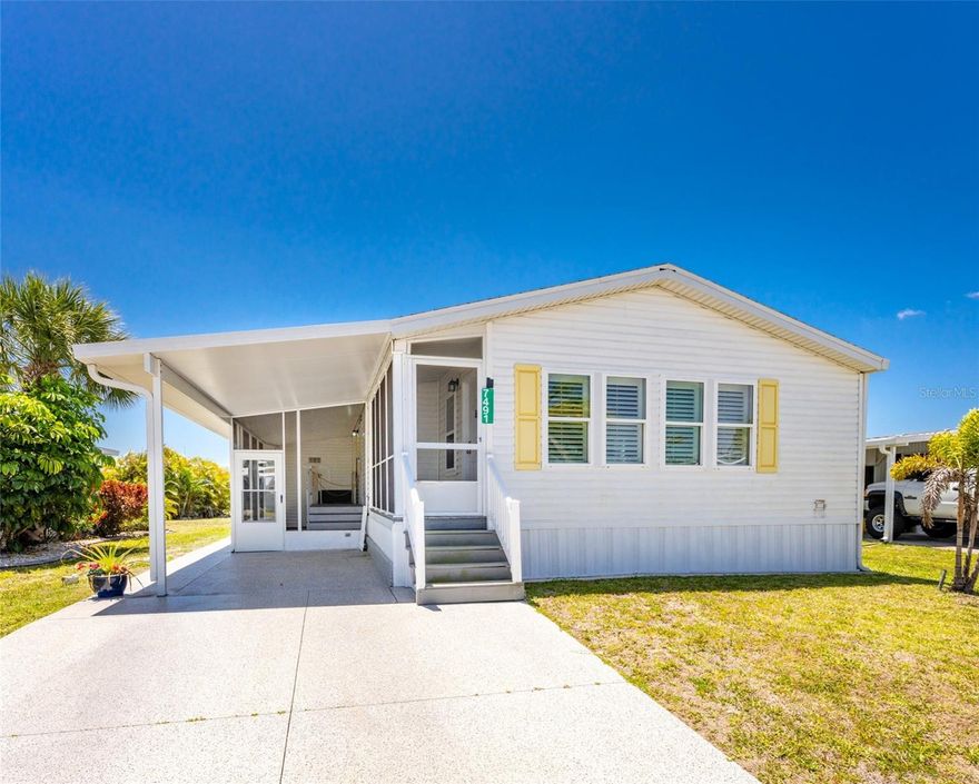 One or more photo(s) has been virtually staged. This SPACIOUS 2002 2-bedroom, 2-bath home offers comfort, quality construction, and LOW HOA fees. Features include a desirable open layout with VAULTED ceilings, a bright 11 X 20 FAMILY ROOM, and SKYLIGHTS that fill the space with natural light. The ISLAND KITCHEN includes a cozy banquette seating area, providing the perfect spot for casual dining and entertaining. You'll find built in closet organizers in both bedrooms maximizing storage efficiency.

Built with durable 2x6 CONSTRUCTION and finished with SHEETROCK walls throughout. RECENT UPGRADS include a NEW ROOF (2022), HURRICANE IMPACT WINDOWS, and a TANKLESS HOT WATER HEATER for energy efficiency.  PLANTATION SHUTTERS add a touch of elegance throughout the home.

Accessibility is a standout feature in this home, with a handicap accessible shower and a wheel chair lift outside for added convenience. 

OWN YOUR LAND! GOLF CART COMMUNITY! ALL AGES WELCOME!

The pool area features a BBQ section perfect for gatherings. There’s always something happening at the large recreation hall, complete with a full kitchen, CRAFT ROOM, and laundry facility, plus dedicated spaces for WOODWORKING, PICKLEBALL, SHUFFLEBOARD, and more.  This property is ideal as a rental investment or your personal winter getaway.  Golf enthusiasts will appreciate several top-rated courses within five miles, while outdoor lovers can take advantage of boating and fishing right from the community docks. Nearby Gulf shore beaches offer even more opportunities to soak up the Florida lifestyle. Dining options abound with local favorites like Gerry’s Tiki Hut, Farlow’s on the Water, and the SandBar Tiki & Grille just a short drive away. Whether you’re looking for year-round living or the perfect seasonal escape, this home offers your chance to own a slice of paradise. A great opportunity to enjoy low-maintenance living with thoughtful upgrades already in place—schedule your showing today!