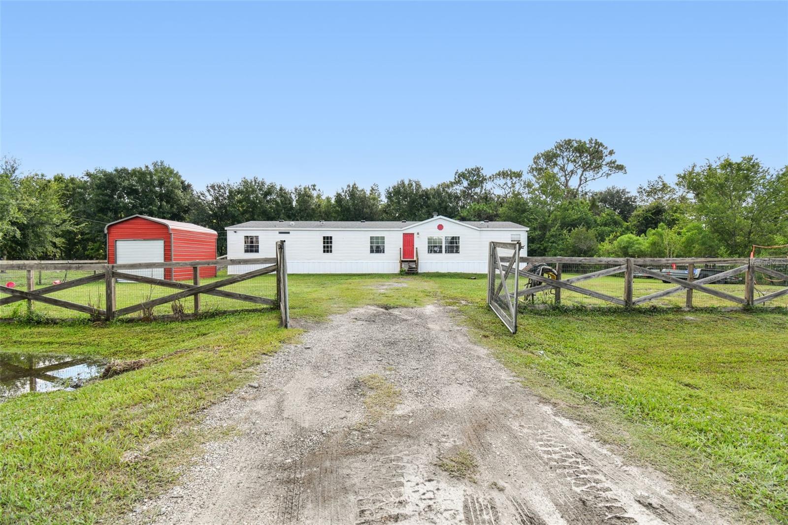 JUST UNDER 4 ACRES!!!!! CHECK OUT this 4 bedroom 2 bath mobile home in Polk City features over 2,356 sqft of living, a beautiful MODERN style kitchen with granite. Newer Vinyl Waterproof floors throughout, newer paint inside, newer remodeled bathrooms and plenty of room for the family!. Quietly sitting on 3.78 Acres, this is country life at this finest!!Bring your horses and all your farm animals, enjoy the view of your beautiful property. Make this your home today perfect for a growing family! Located just north of I-4 with an easy drive to shopping, dining, schools and much more!!! Call for a showing today!!!!